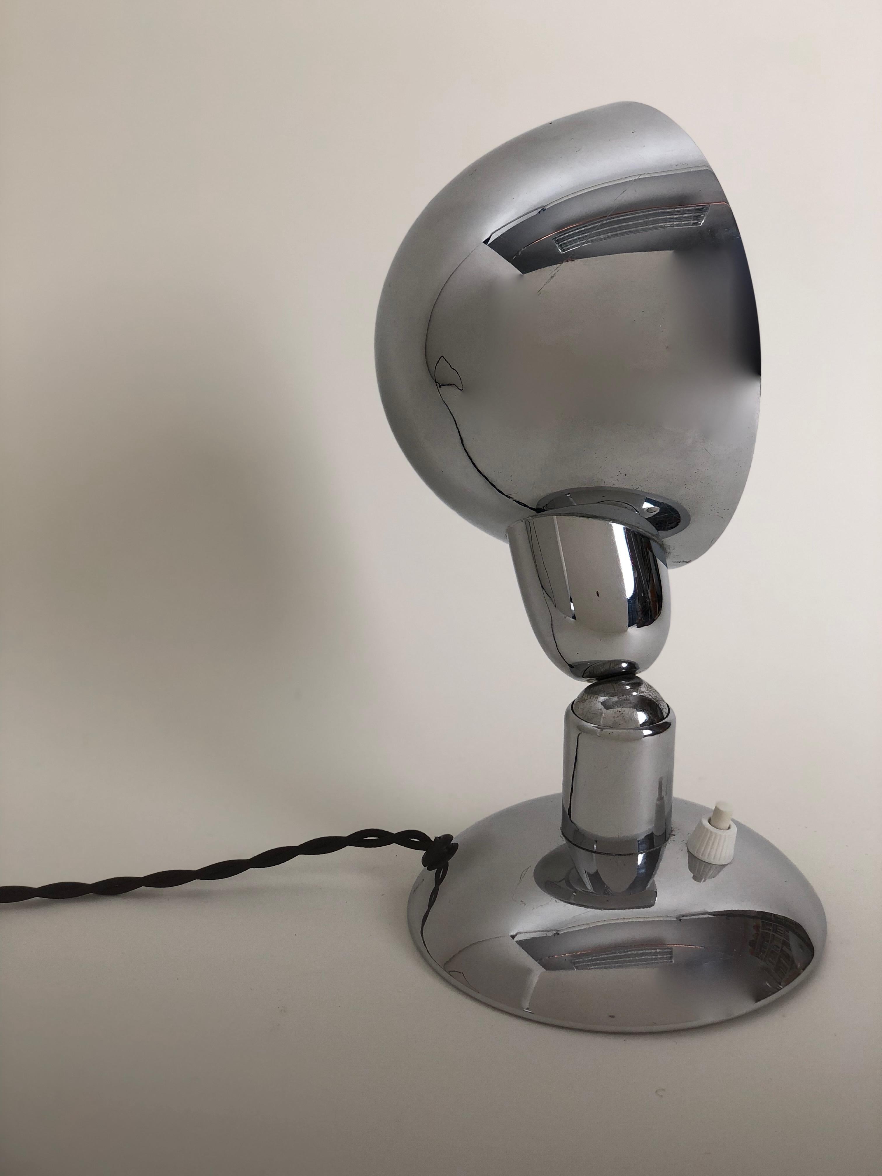 An unusual WMF Ikora lamp from the 1930 s in chrome. It has a ball and socket system to very the angle of the shade in relation to the table and wall. The shade can be rotated as well. The design is reminiscent of the Bauhaus. It has new electrical