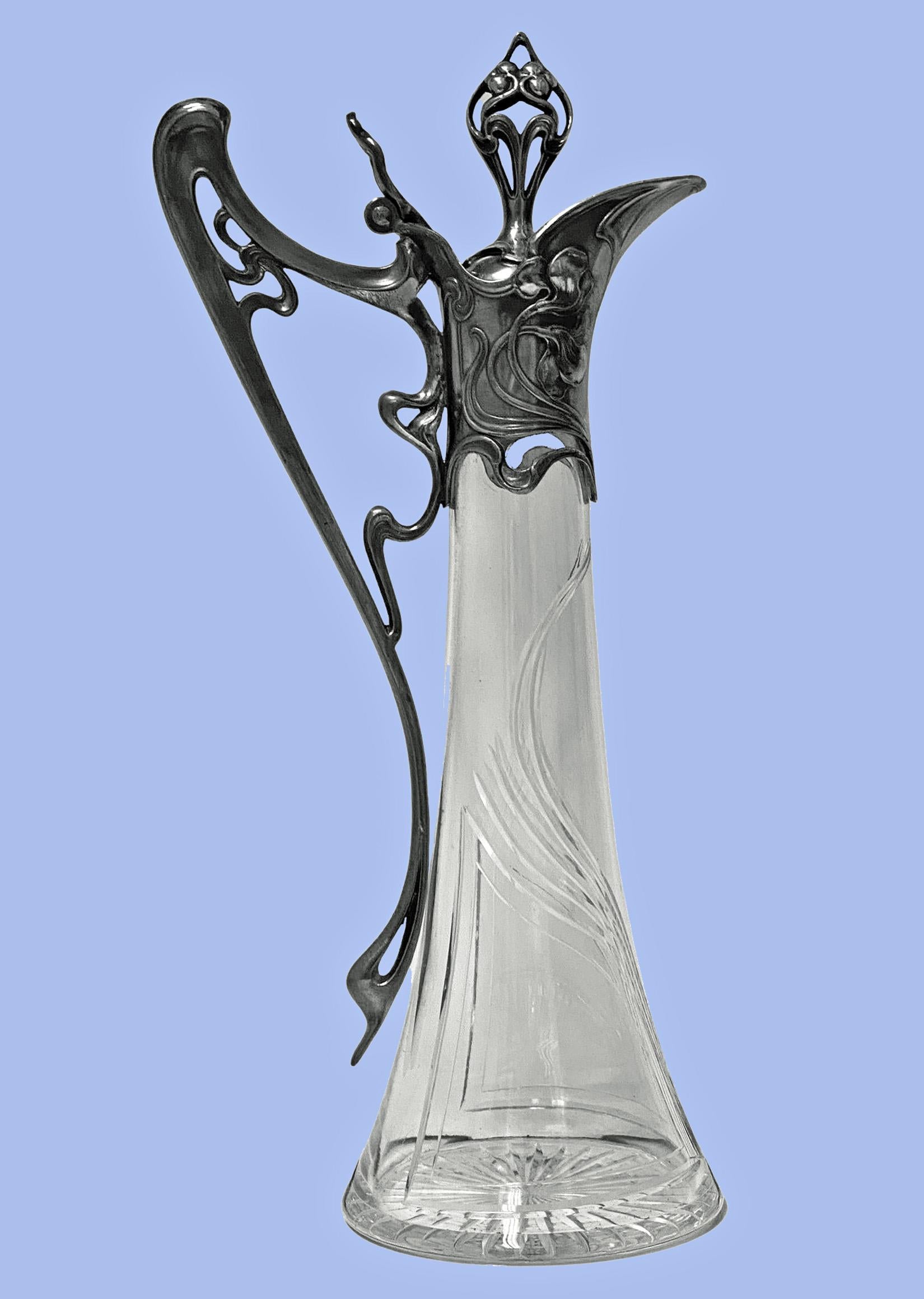 WMF Jugendstil Art Nouveau Claret Jug, C. 1905. Jugendstil Antique Silver finish Britannia Metal and finely cut crystal. Decorated with Art Nouveau floral motifs a WMF iconic design. Excellent antique condition, antique silver finish, original