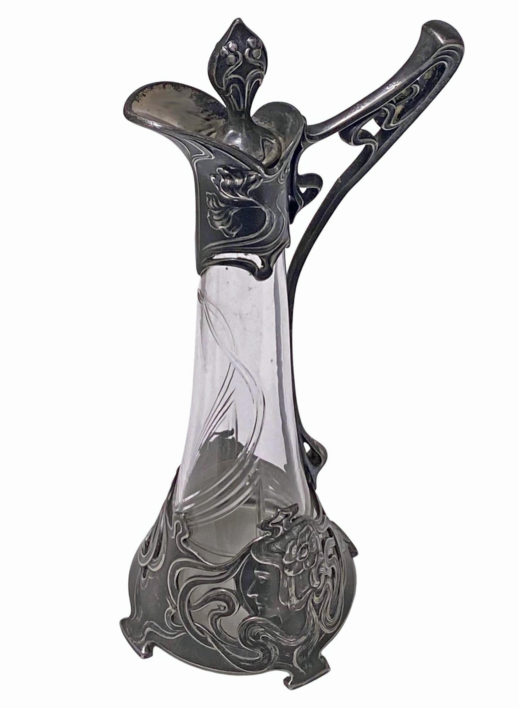 WMF Jugendstil Art Nouveau Liqueur jug, C. 1900. Jugendstil Metalwork featuring Art Nouveau motifs of maiden and floral design both on the metal and on the cut glass crystal body, a WMF iconic design. Excellent antique condition, antique silver