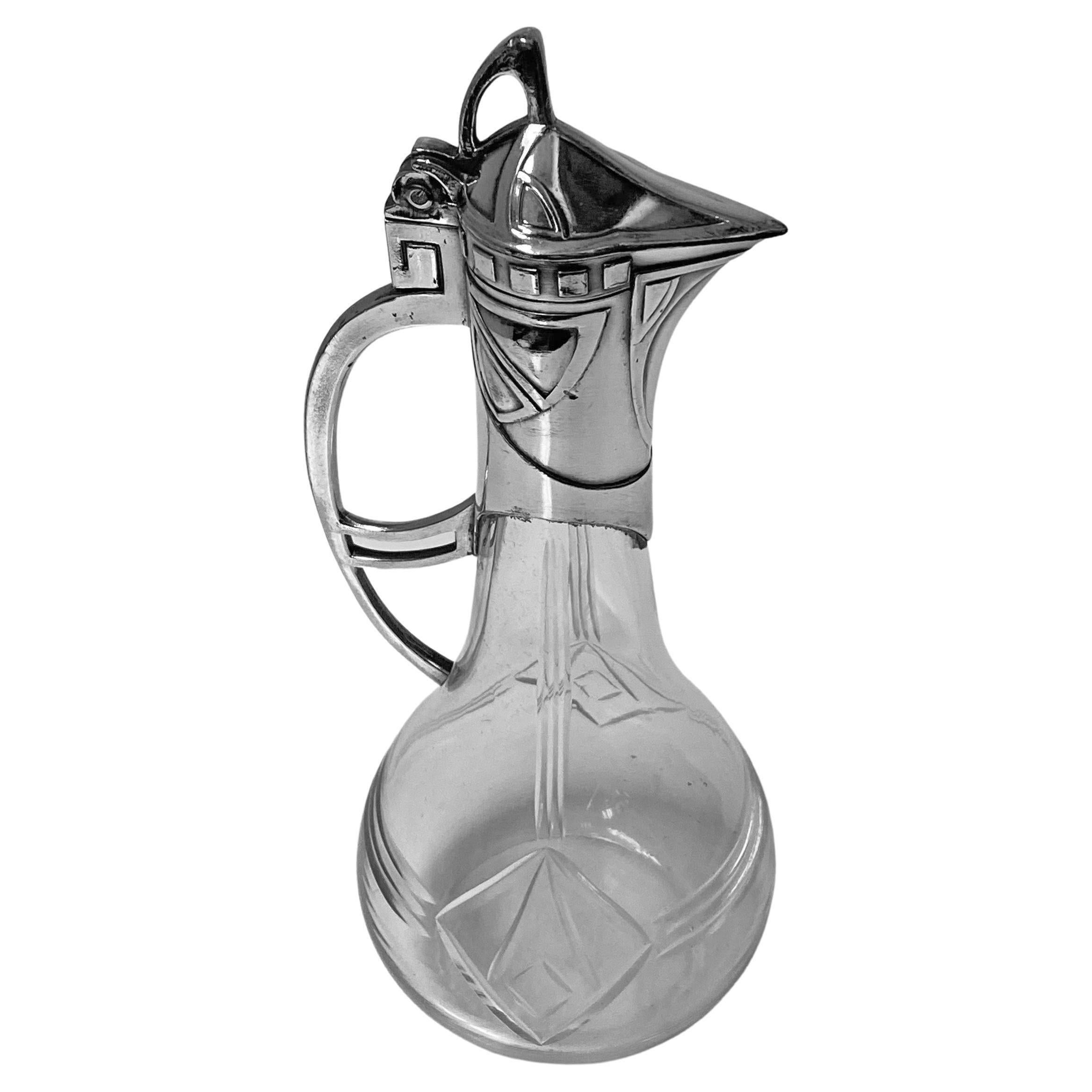 WMF Jugendstil Art Nouveau liqueur jug, C. 1900. Jugendstil Metalwork featuring Art Nouveau design both on the silvered britannia metal and on the cut glass crystal body. Good antique condition, antique silver finish, original patina, extreme minor