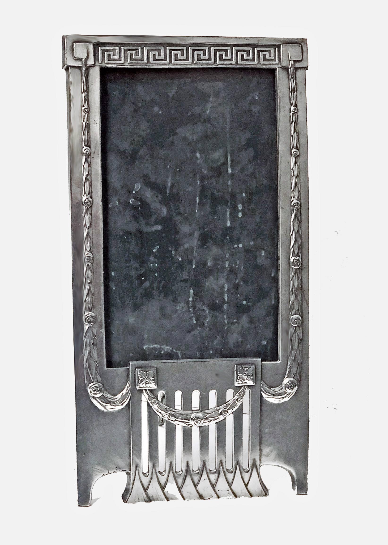 WMF Jugendstil Art Nouveau Secessionist Photograph Frame, Germany C.1905. The rare design pewter frame of horizontal rectangular shape with elongated open panel triangular panel lower frieze , the surround of frame festoon wreath and greek key