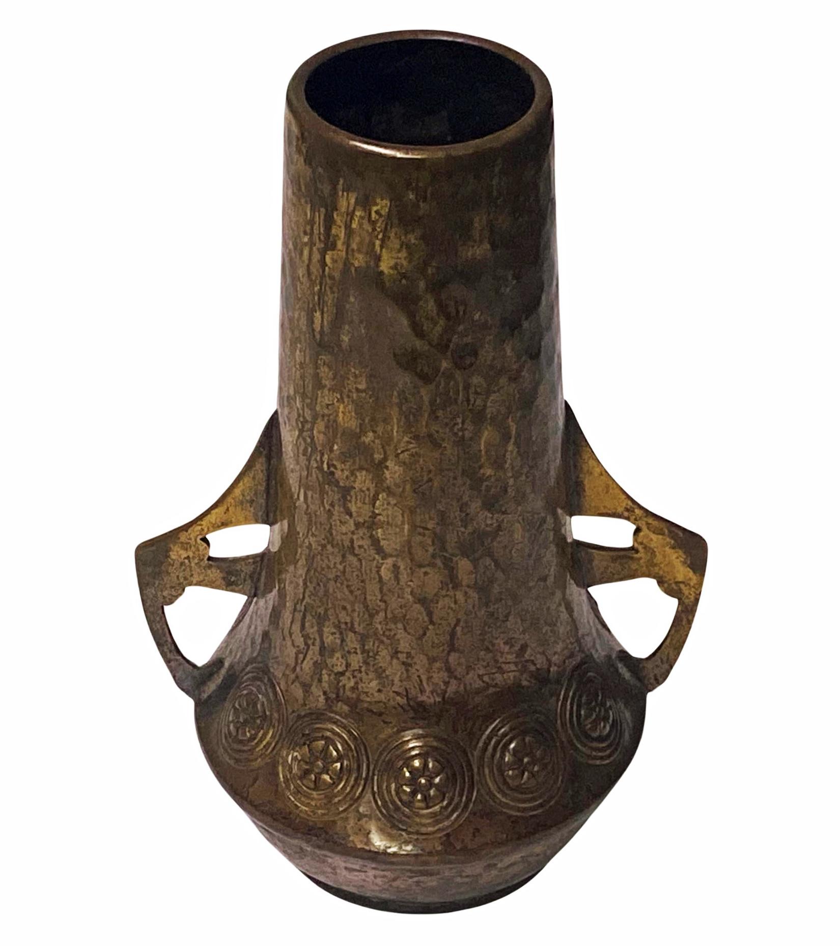 WMF Jugendstil small Vase C.1910. The vase of hammered patinated bronze. WMF beehive mark and design number 64 to base. Height: 4.25 inches. Handle to handle: 2.75 inches.