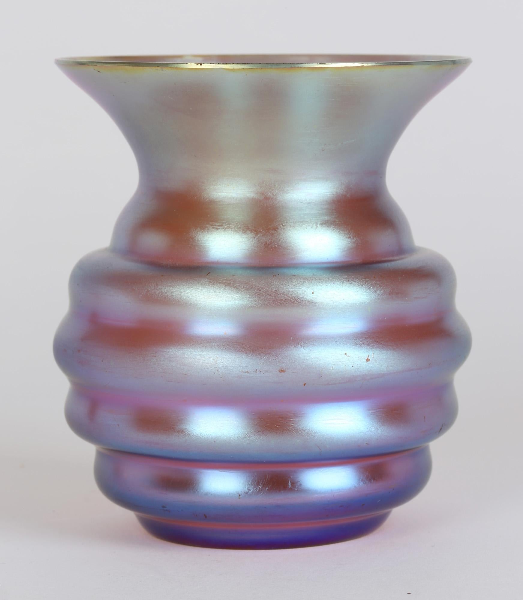 A very fine German Art Deco Myra Kristal amber glass vase with a wonderful blue iridescence vase made by WMF (Württembergische Metallwarenfabrik) and dating between 1926 and 1936. Designed by Karl Wiedmann this stylish vase stands on a narrow