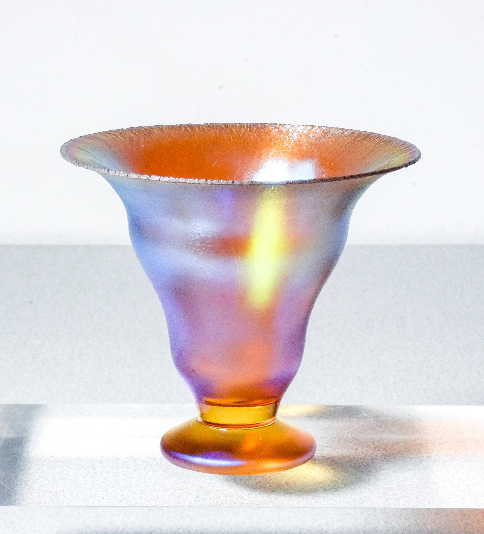 WMF Myra-Kristall.
Iridescent blown glass vase.

ORIGIN
Germany

PERIOD
30s

BRAND
WMF

DESIGNER
Karl Wiedmann

MATERIALS
Iridescent blown glass

DIMENSIONS
Ø 12.5 x H 11 cm

CONDITIONS
The piece is in excellent condition, as