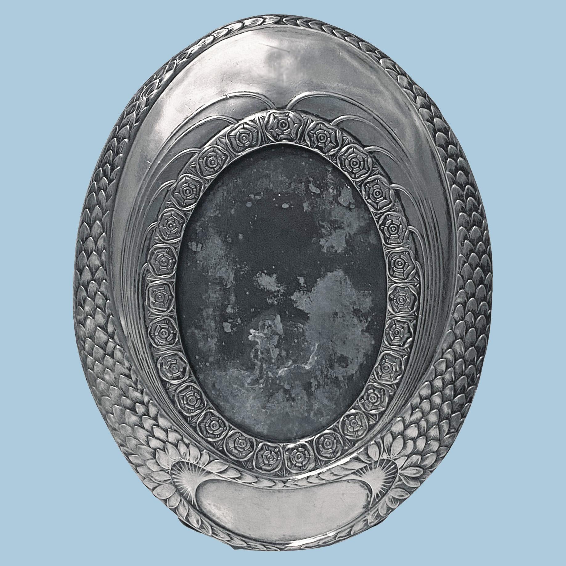 WMF large pewter oval photograph frame C.1910. Relief decorated with a band of roses within a border of overlapping leaves, WMF marks to reverse and B O/X and model number 98. Original back and easel. Overall: 10.00 x 7.50 inches. Image size: 5.50 x