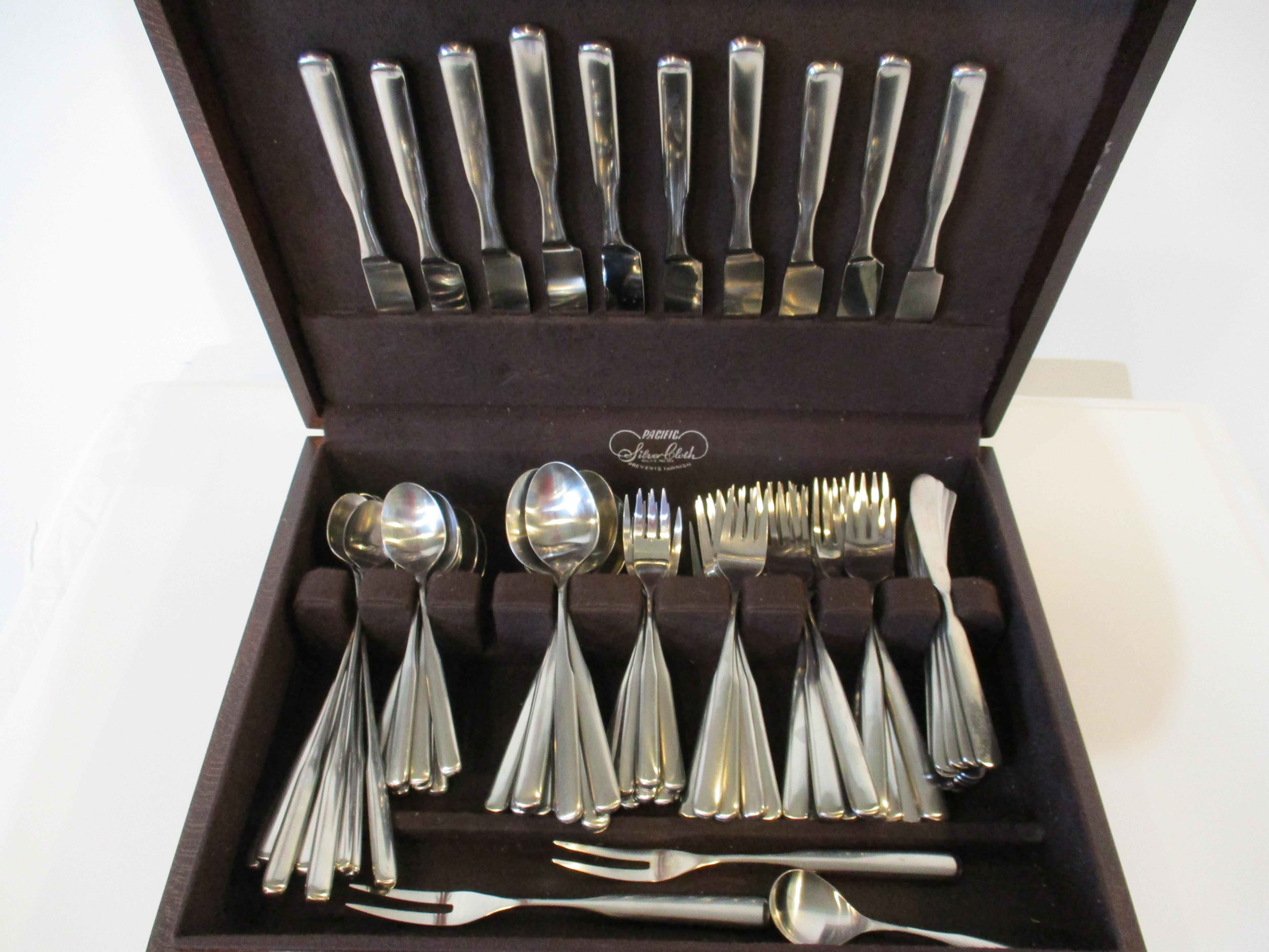 A 83 piece mid century stainless steel flatware set with 10 place settings of eight pieces including 10 large forks, 10 salad forks, 10 dinner knifes, 10 butter knifes, 10 long ice tea spoons, 10 tea spoons. 10 soup spoons and 10 desert forks. Also