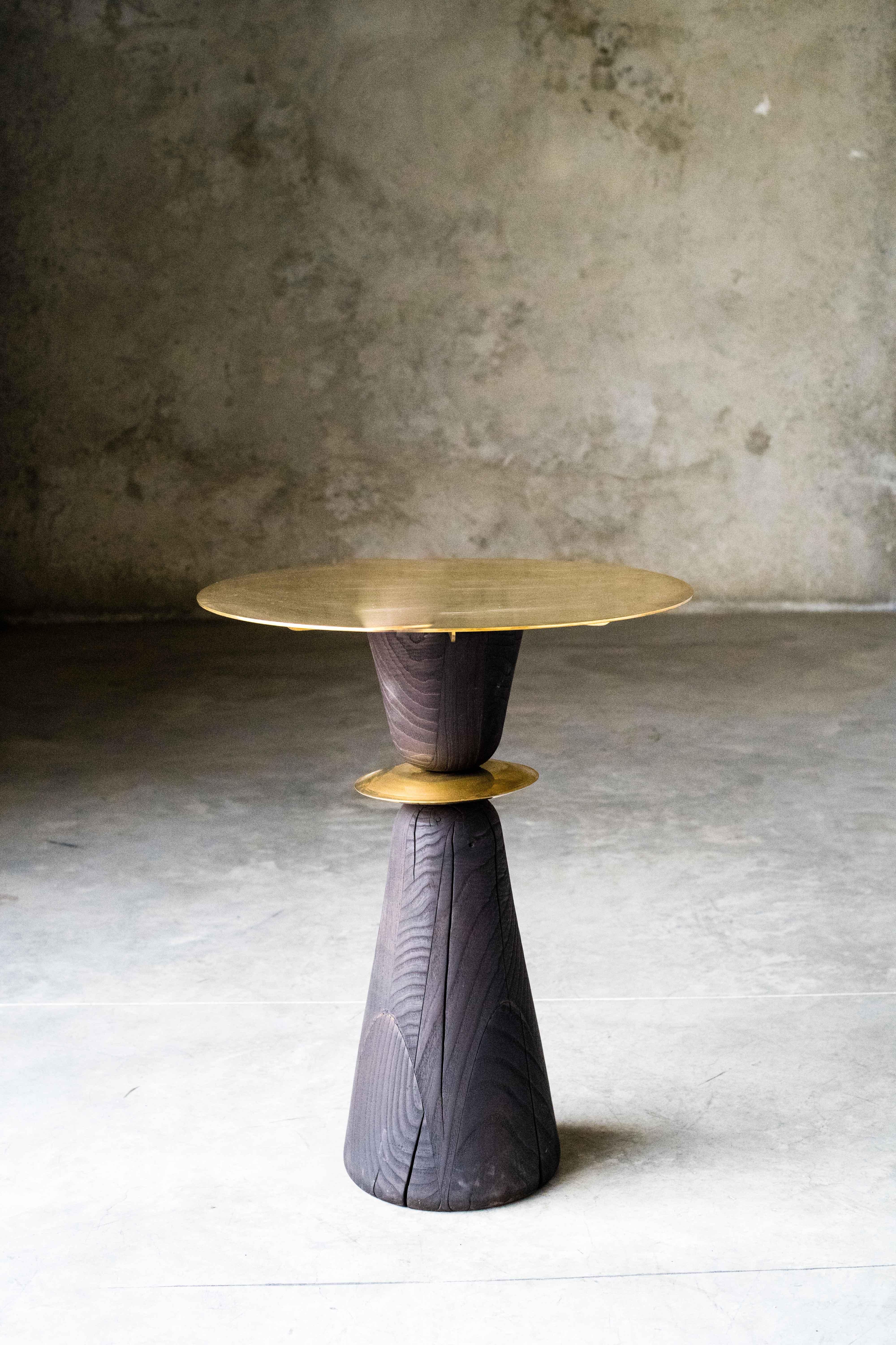 WMF small table by MOB
Limited editions of 5 + 1 prototype
Designer: Alejandra Prieto and Pablo Valle (Chile)
Dimensions: H 72 x W 70 cm
Material: Polished bronze, Chestnut wood, Shou-Sugi-Ban (Yakisugi) treatment

The WMF is a small pedestal