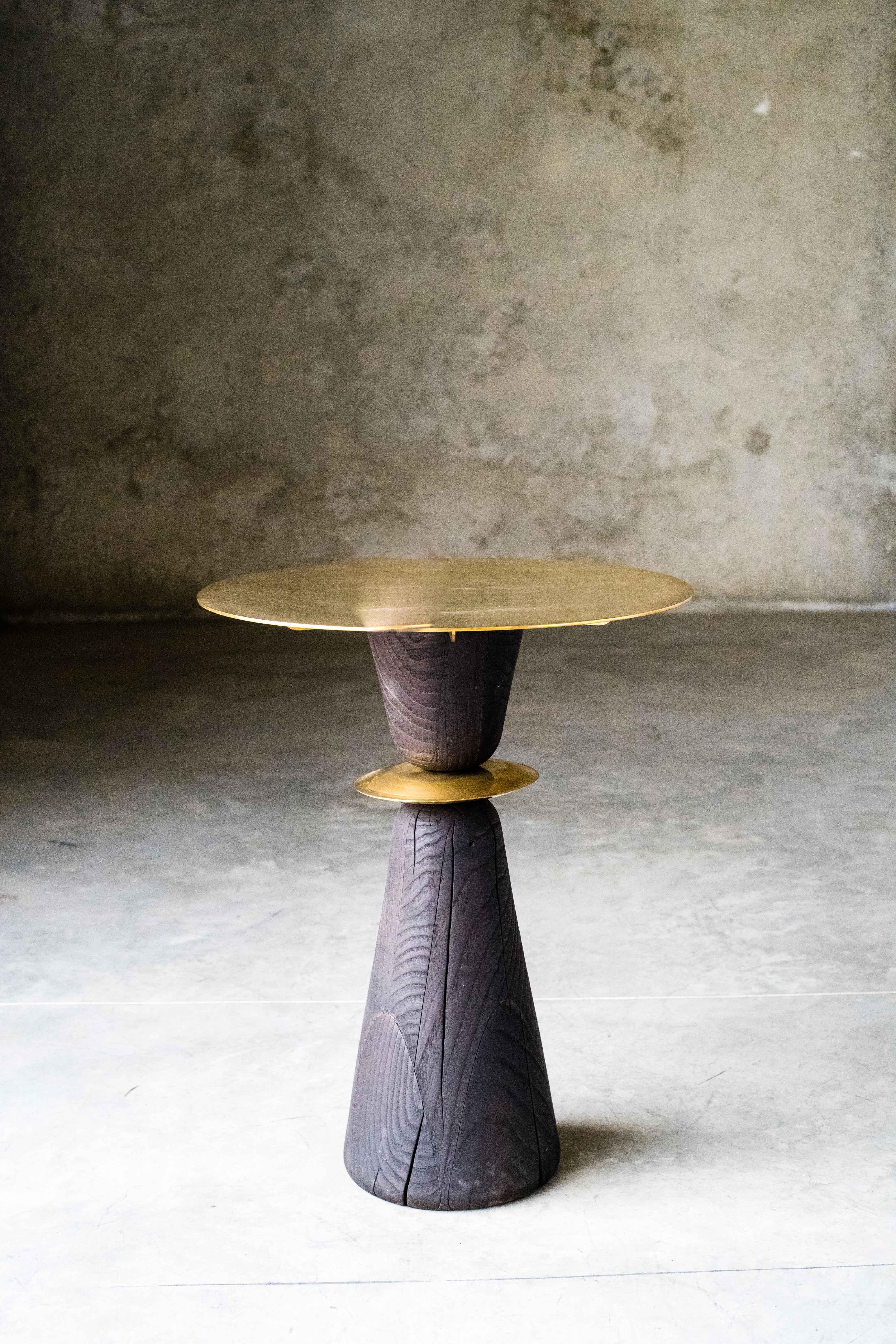 WMF small table by MOB
Limited editions of 5 + 1 prototype
Designer: Alejandra Prieto and Pablo Valle (Chile)
Dimensions: H 72 x W 70 cm
Material: Polished bronze, chestnut wood, shou-sugi-ban (Yakisugi) treatment

The WMF is a small pedestal