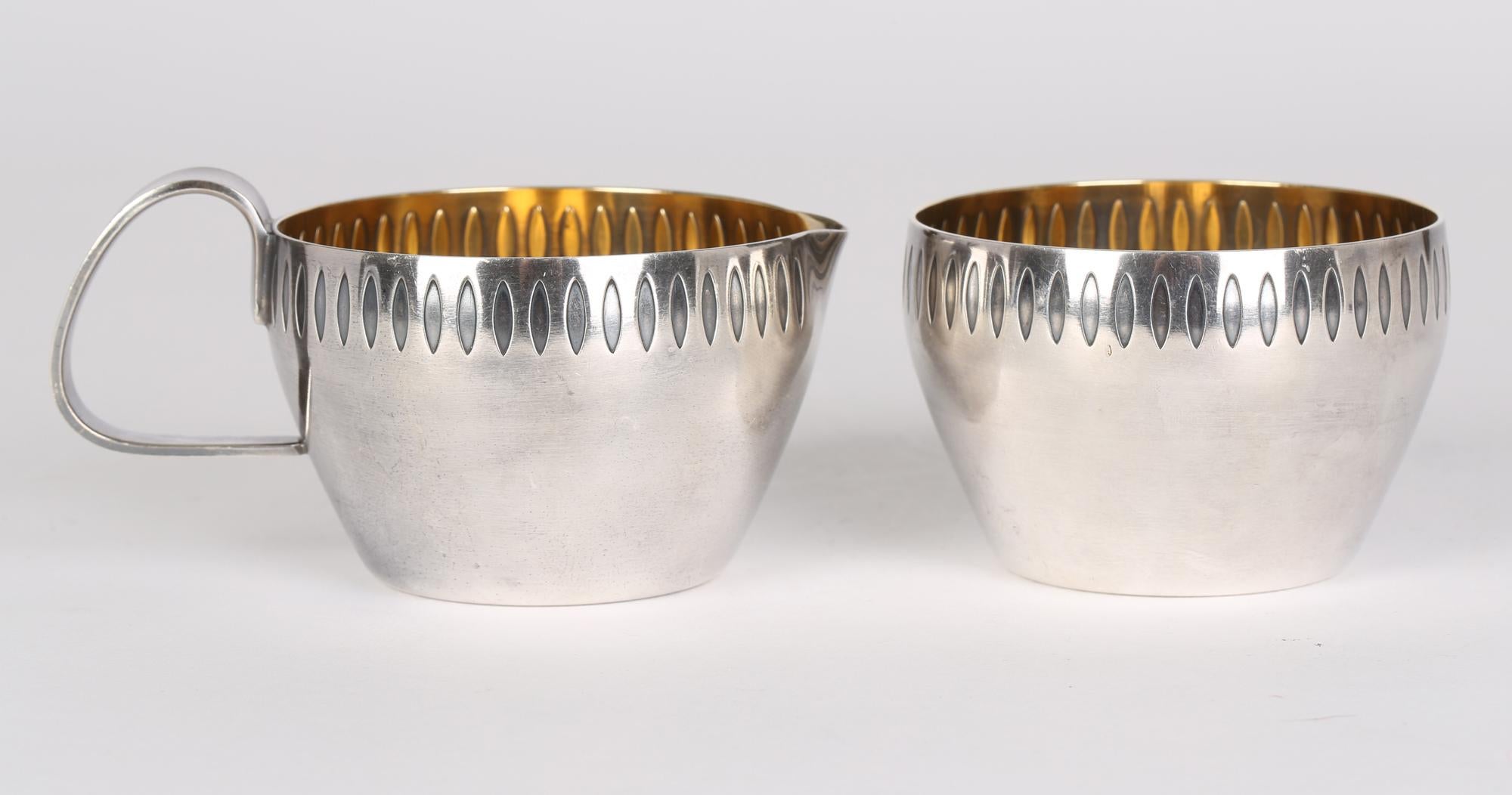 Stylish WMF (Würtemburgische Metallwaren Fabrik) Art Deco silver plated sugar bowl and cream jug with an impressed seed design dating from around 1935. The simply formed but quality pieces are made in thick gauge metal with a silvered exterior and