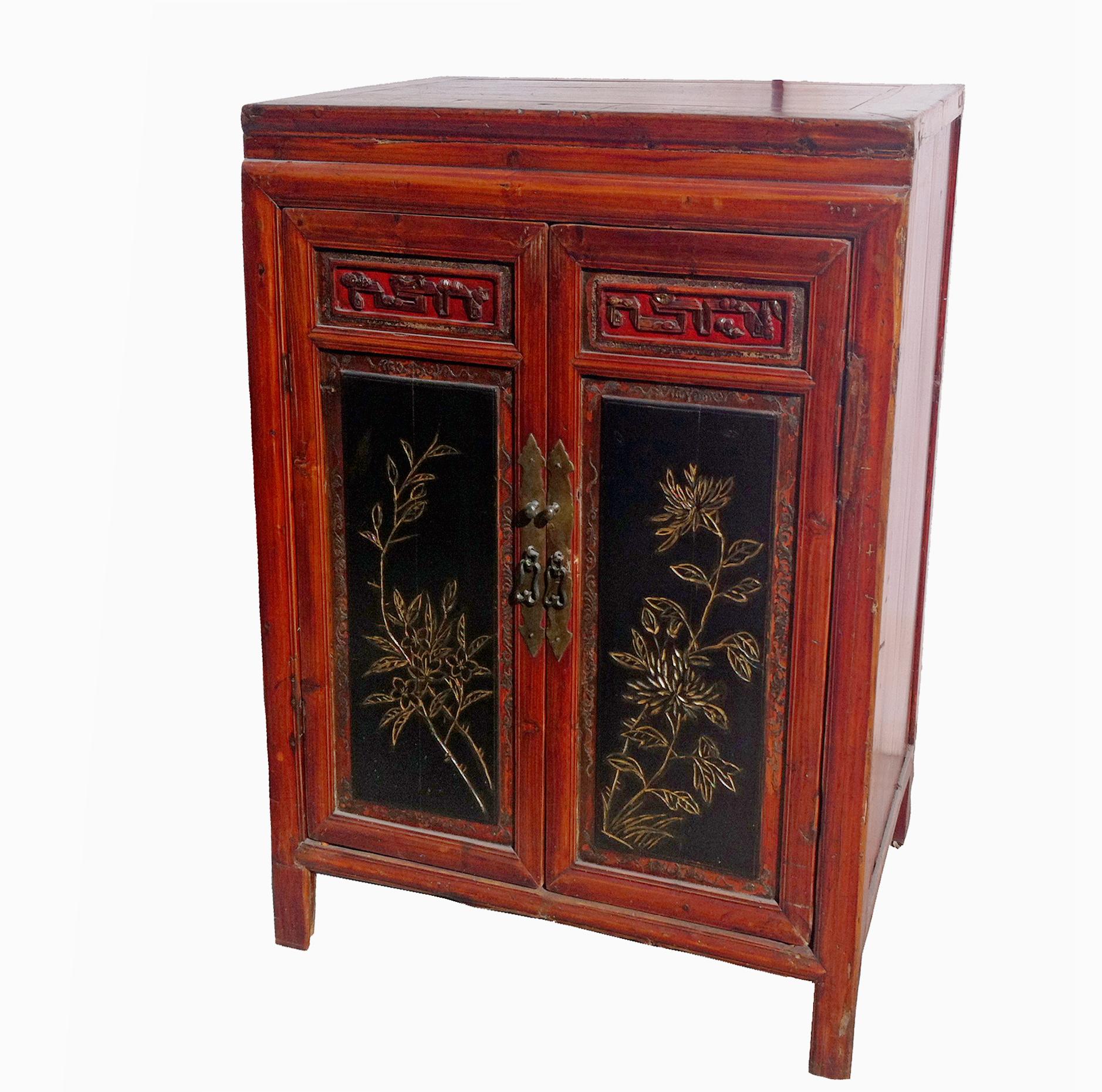 This antique Fujie cabinet with hand carved doors and elegant hardware will add understated sophistication to your living room or bedroom. Golden flowers emboss two door panels which open to reveal two spacious shelves. This size stand is perfect