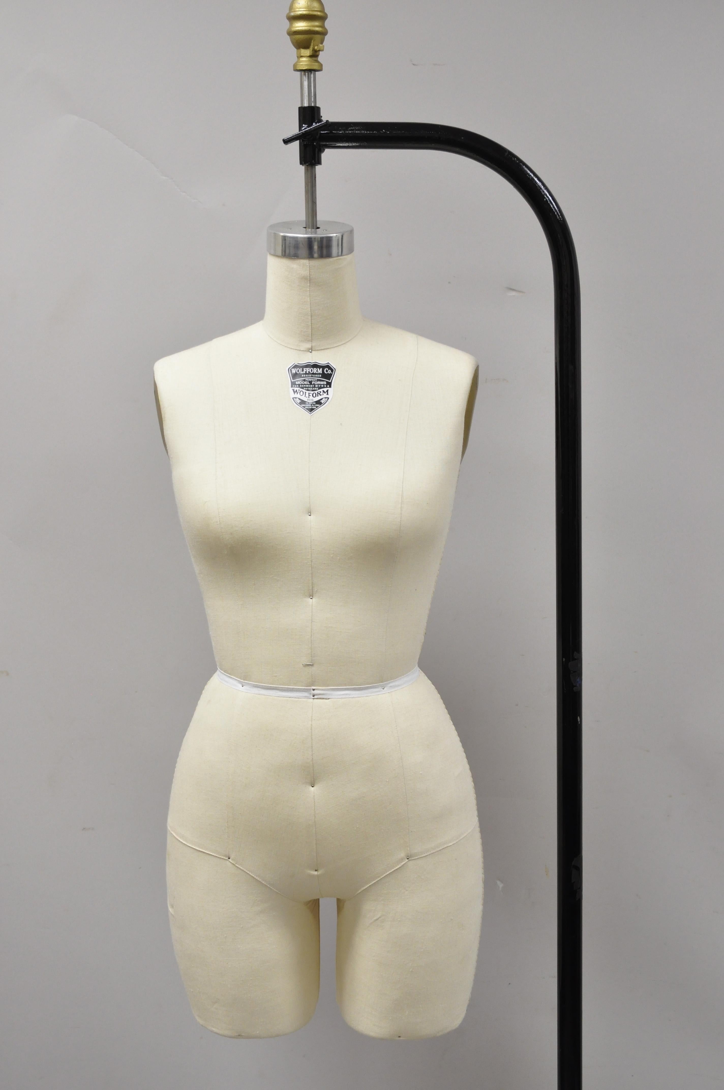 Wolf model Form & Co cast iron adjustable rolling stand dress form mannequin. Item features collapsible shoulders, adjustable height, rolling base, cast iron stand, circa late 20th century. Measurements: 69