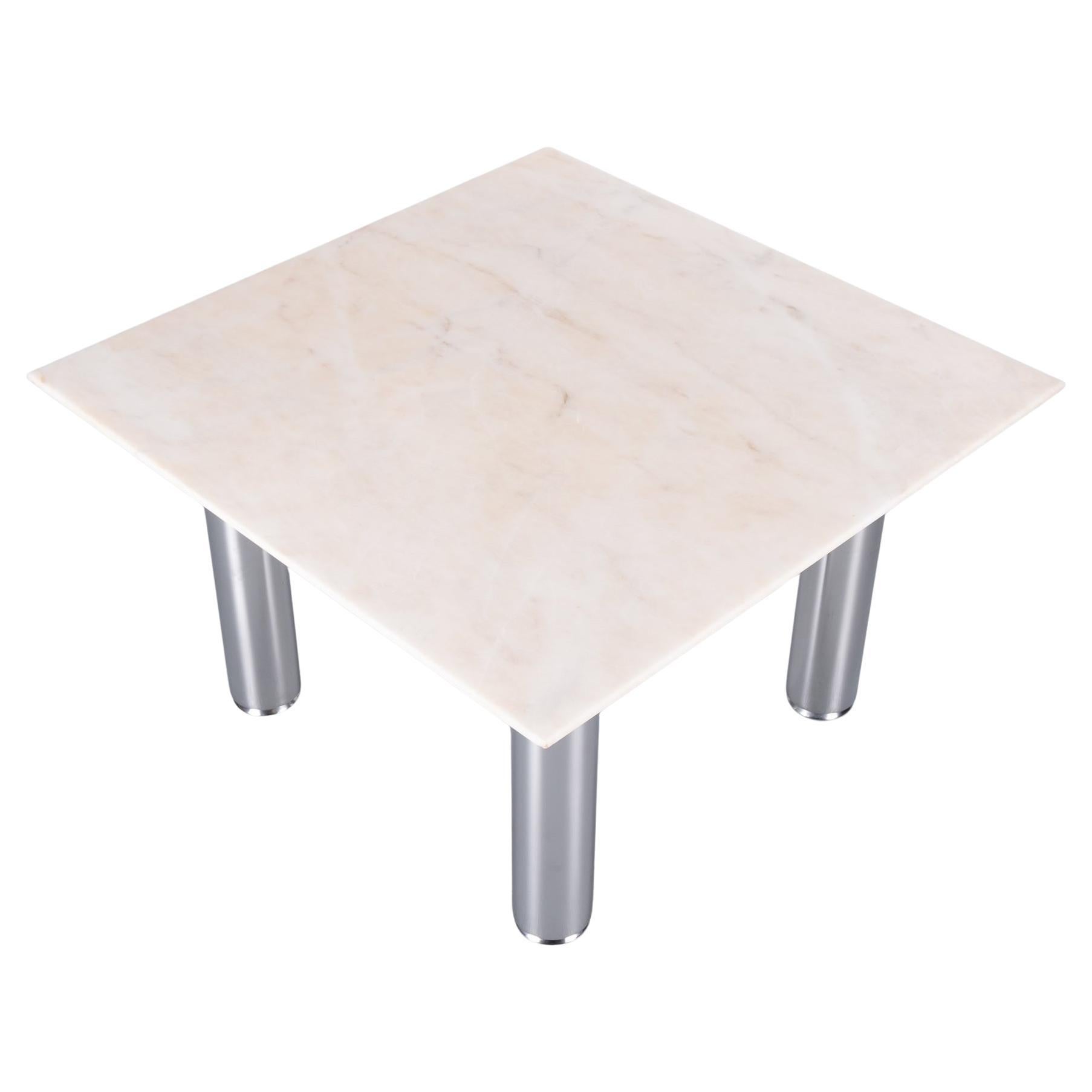 Very nice elegant square coffee table. Thin Marble top in a slightly pink color. Comes with robust brushed steel. legs .The legs are adjustable in height.  Very good quality table .
The thin marble top seems to float. Very good condition.  
Design