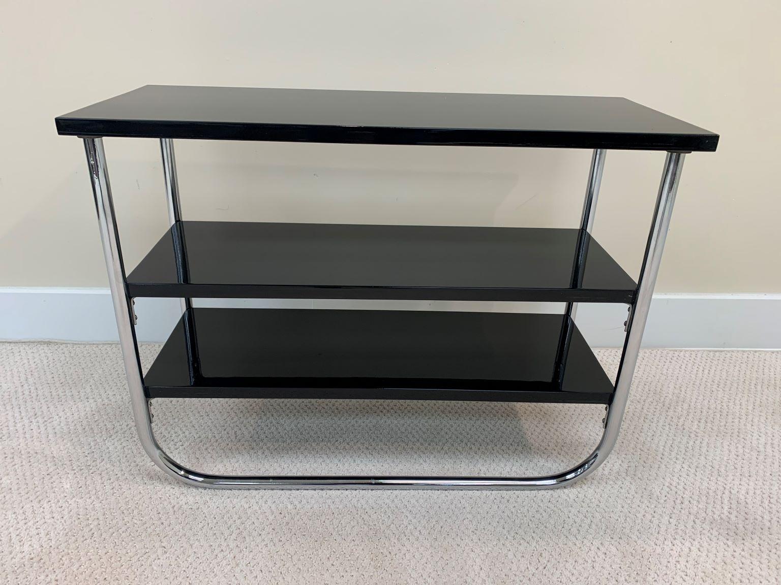 A beautiful three-tiered polished chromed and black lacquered table by Wolfgang Hoffman. Wolfgang Hoffman designed this elongated side table for the Howell Furniture Company in 1937, model number 419. Expertly restored. Reference in Howell’s 1937