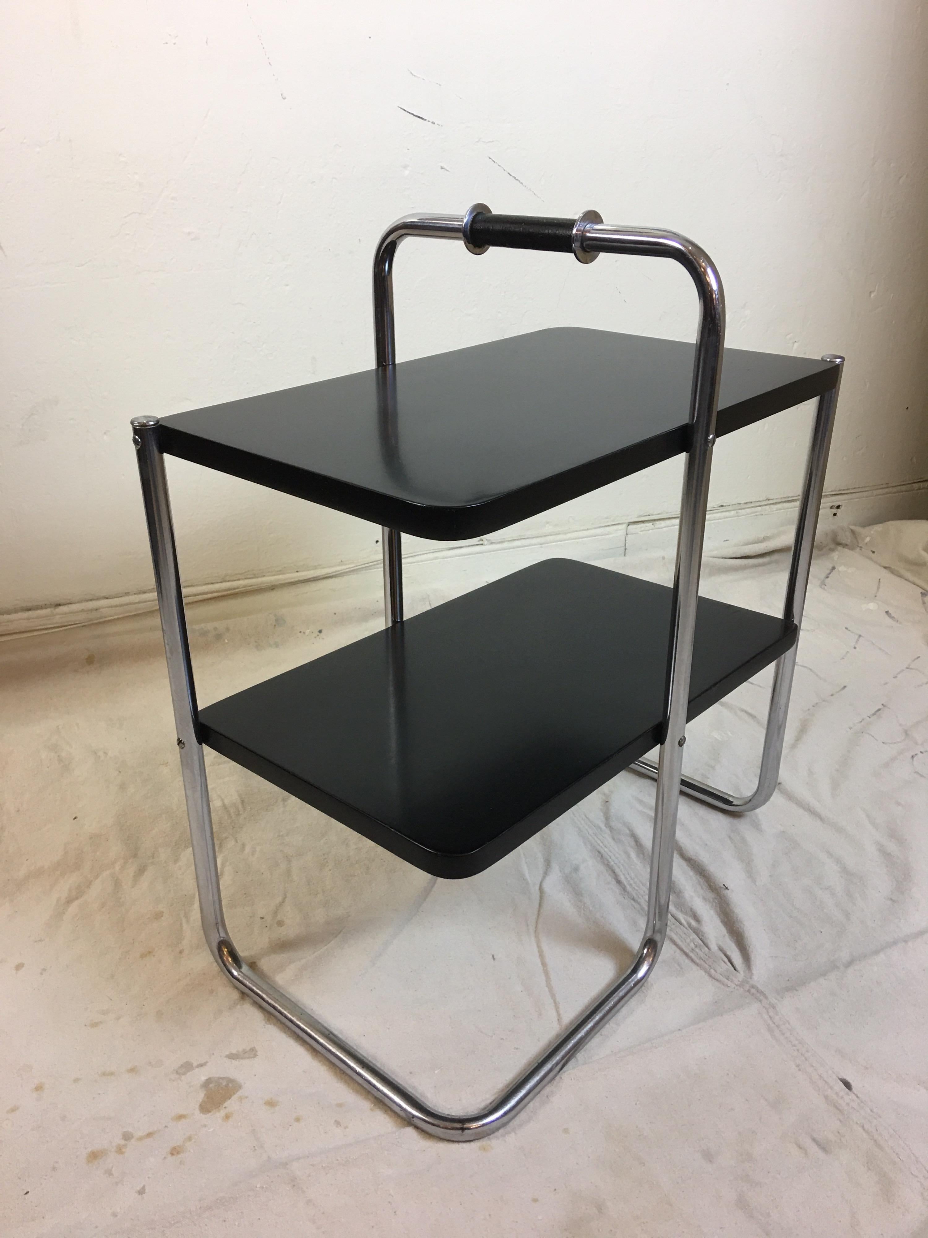 Wolfgang Hoffmann for Howell end table model 305. Hard to find little table not often seen! Black lacquered tops just refinished. Chrome is very nice and appears original. Last photos as it appears in a 1935 catalog.