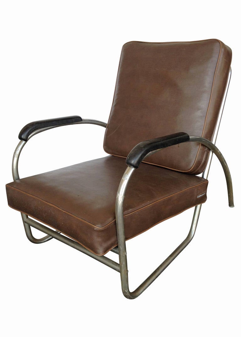 Made by Royal Metal Manufacturing, this Wolfgang Hoffmann style club chair features a heavily made chromed round tubular frames with heavy double bated cushions.

The arms of this chair features a graceful streamline moderne shapes connected to a