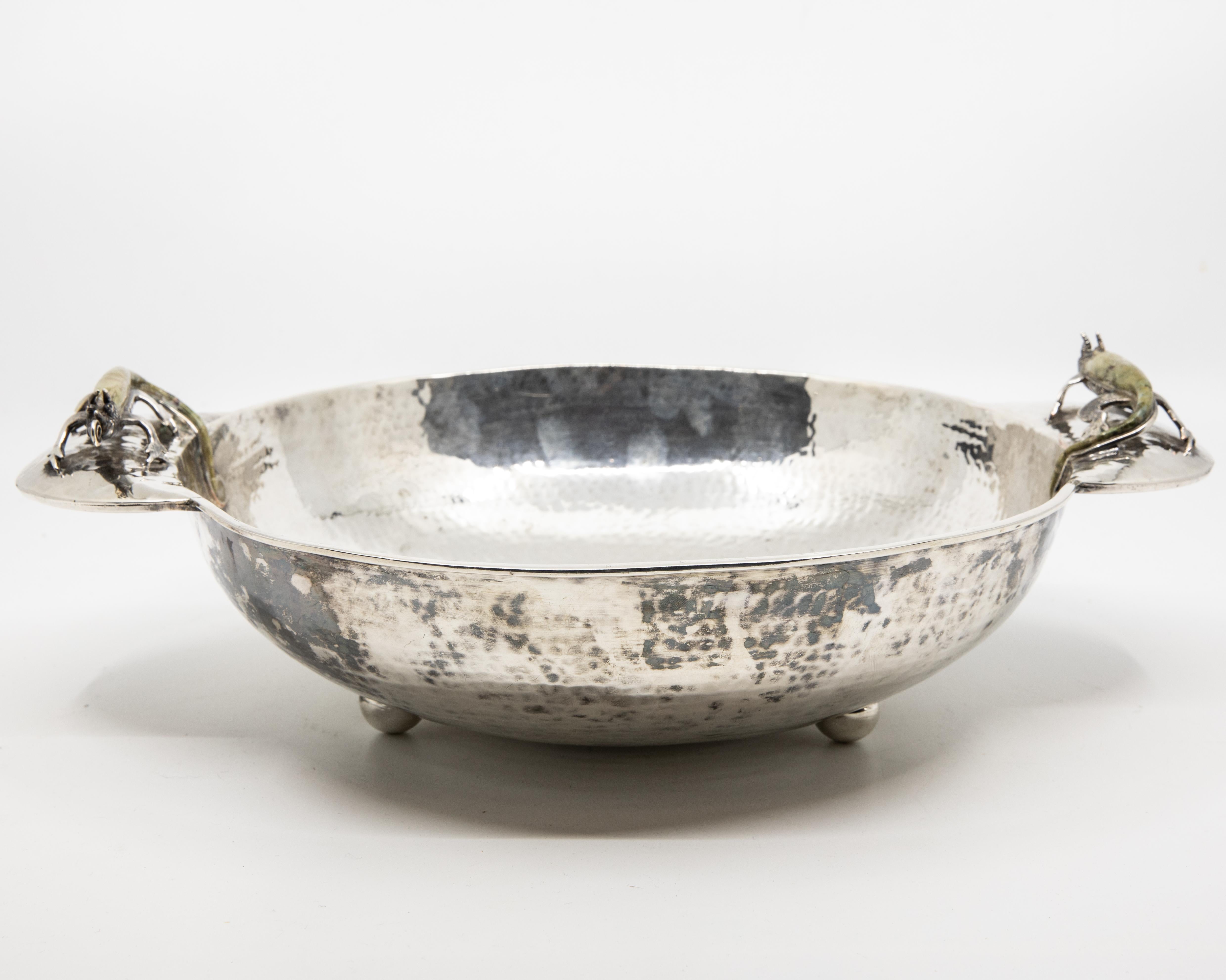 Offered is a Wolmar Castillo circa 1960s hand-hammered Taxco silver plated copper. The bowl has Iguana handles that are set with green stones. Marking on bottom reads 