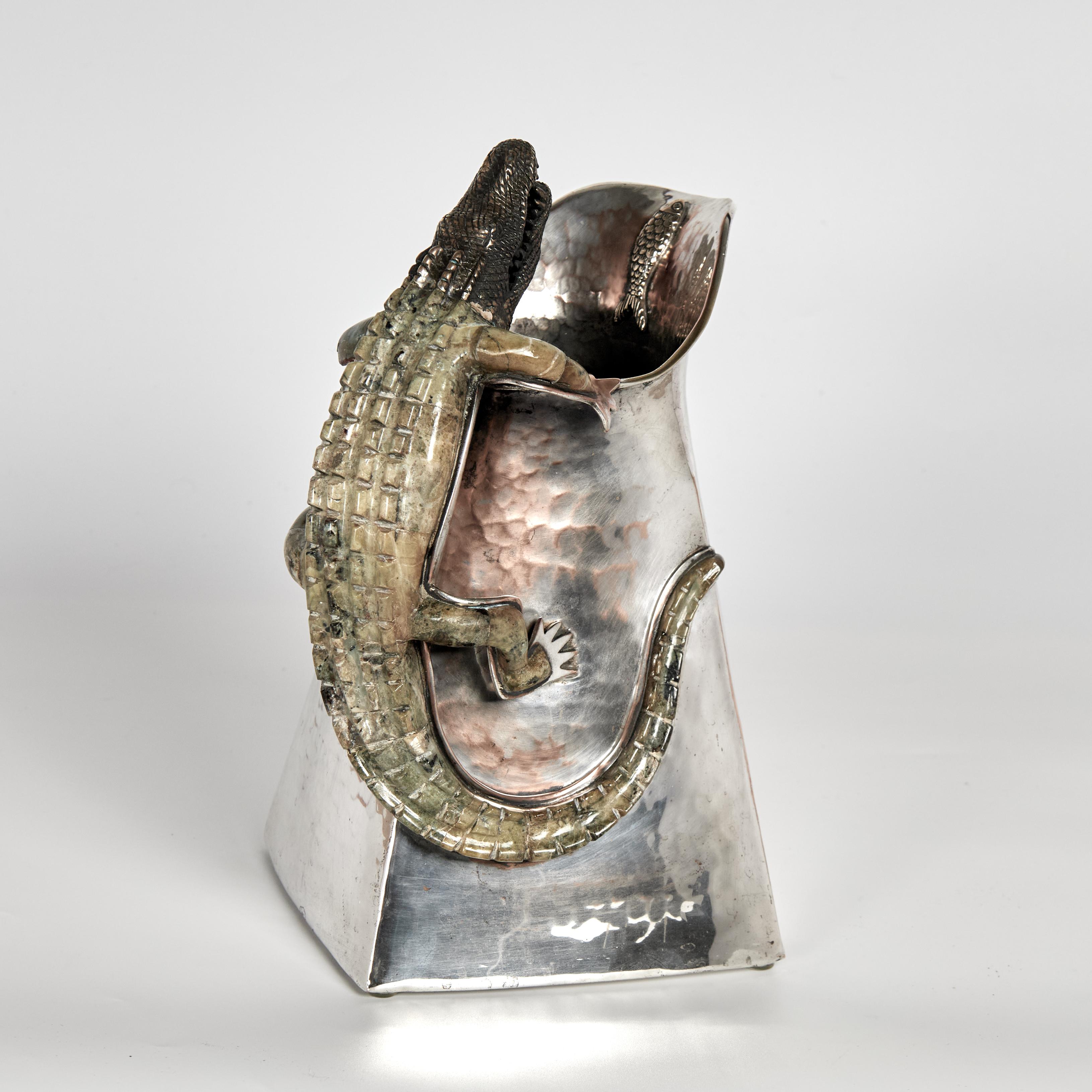 Unusual mid century Mexican pitcher handcrafted in silver plate on hammered copper in a modern cubist form featuring a stone clad alligator as a handle and a fish on the spout. Stamped Wolmar Castillo on the bottom.