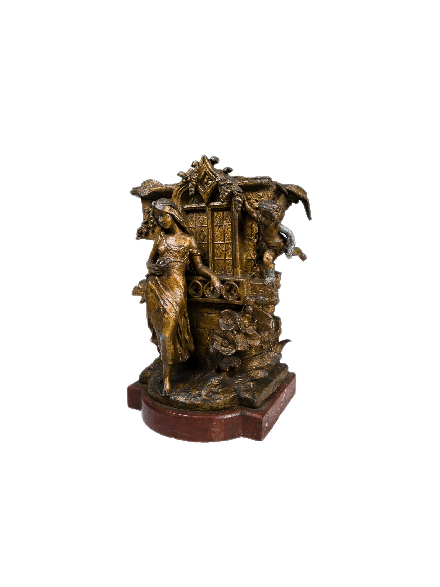A 19th-century Baroque Revivalist bronze jardiniere featuring a window in the Baroque style, gargoyles, a woman, and cherubim amidst the flora engulfing the building 