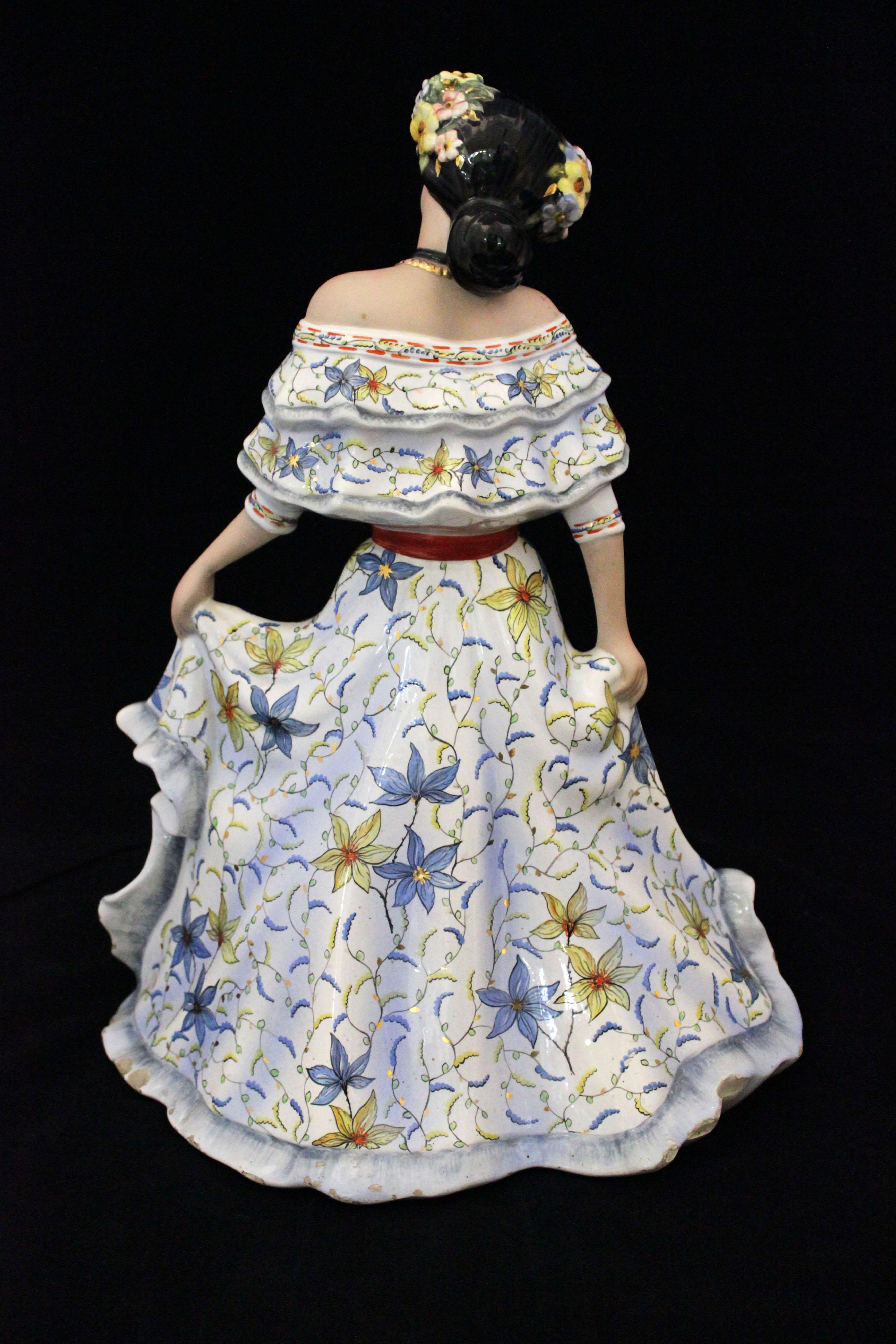 Generously sized ceramic figure, depicting a happy latin girl, dressed in makeup and festive dress. Finely sculpted and painted, the colors are united with the joyful character of the girl, giving the already large work a strong positive impact. On