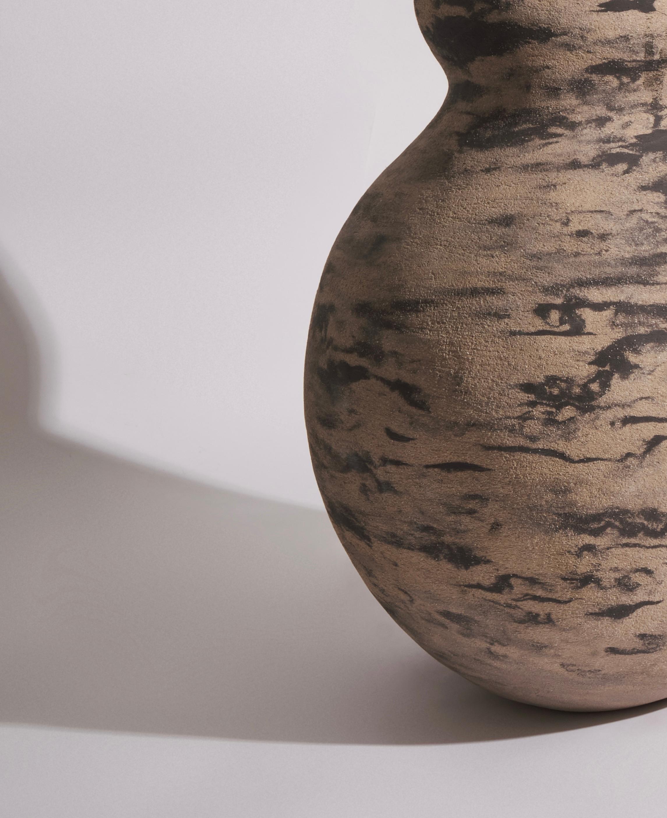 The ceramic body vessel, standing at a 70 cm height, is a creation that elegantly embodies the duality of clay - fragile yet strong, much like the resilience of a woman. The coiling method i employed to craft this piece adds depth and texture to its