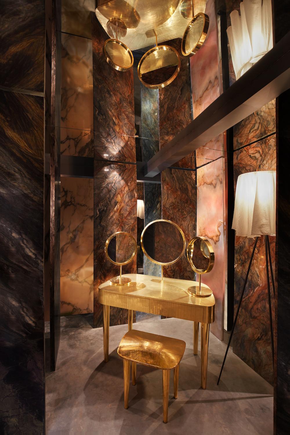 Woman in Paris Vanity Table in Brass by Matteo Cibic is an opulent vanity table with brass inlay. It has two drawers and three mirrors, two of which can be moved to desired angles. 

Matteo Cibic designed the Vanilla Noir collection for Scarlet