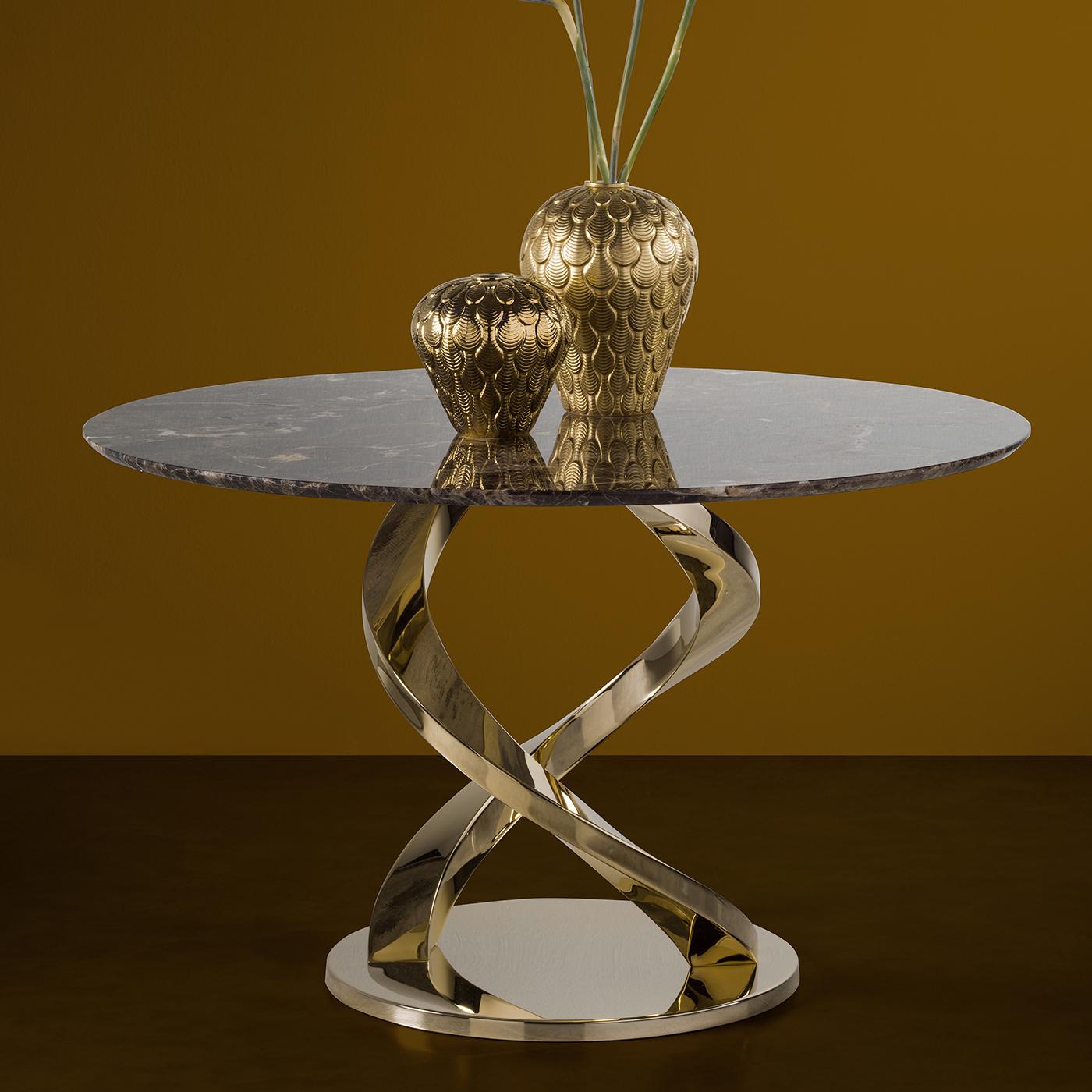 Part of the Home Couture collection, this side table is a modern reinterpretation of bold and sensual Art Deco furniture. Its marble top serves a stately display for lamps or collectibles, while the base, with its 24-karat gold-plated stainless