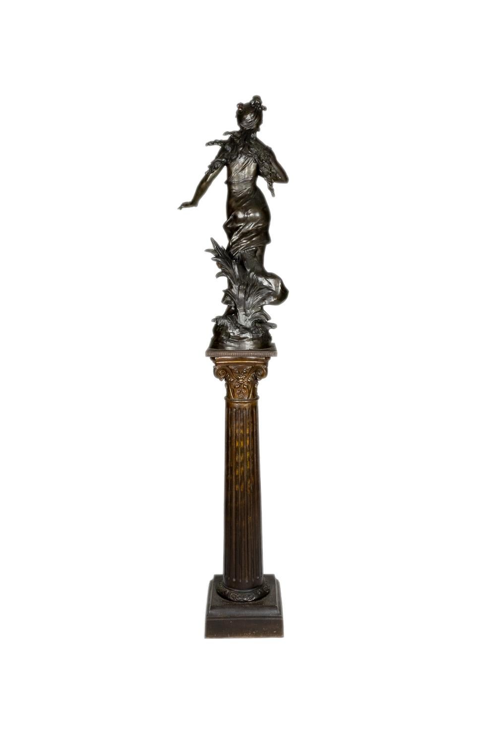 A Woman with Roses 19th Century spelter statue and column of a young woman in a flowing dress, rose garland on her head and rose on her lapel, a floral motif, signed“Aug Moreau” on the  base.

Height Total 73,62 in (188 cm)
Height column 40,15 in