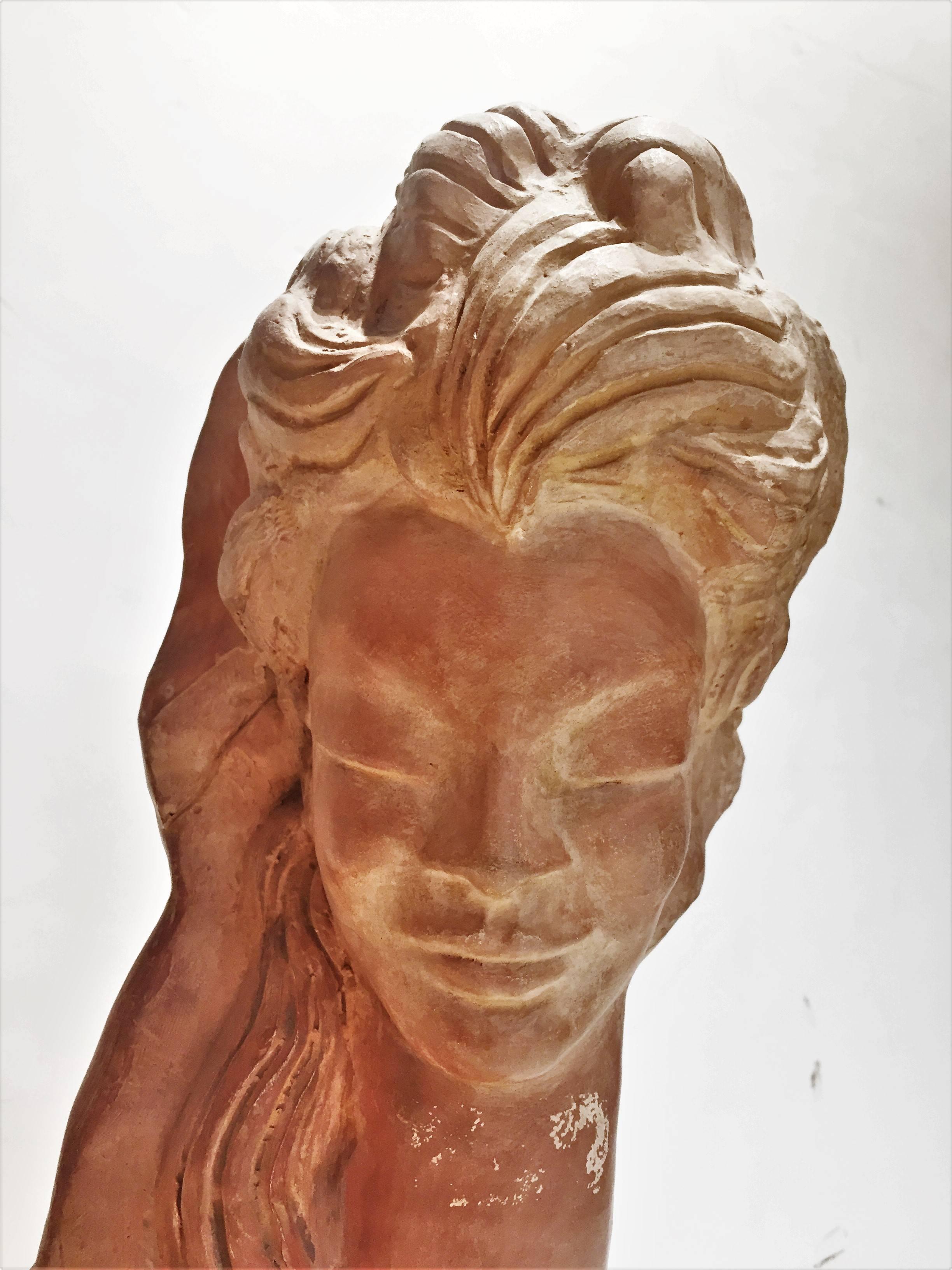 Elegant in its simplicity, this bust depicts the head of a beautiful young woman with her hair spread out over her shoulders and her eyes closed