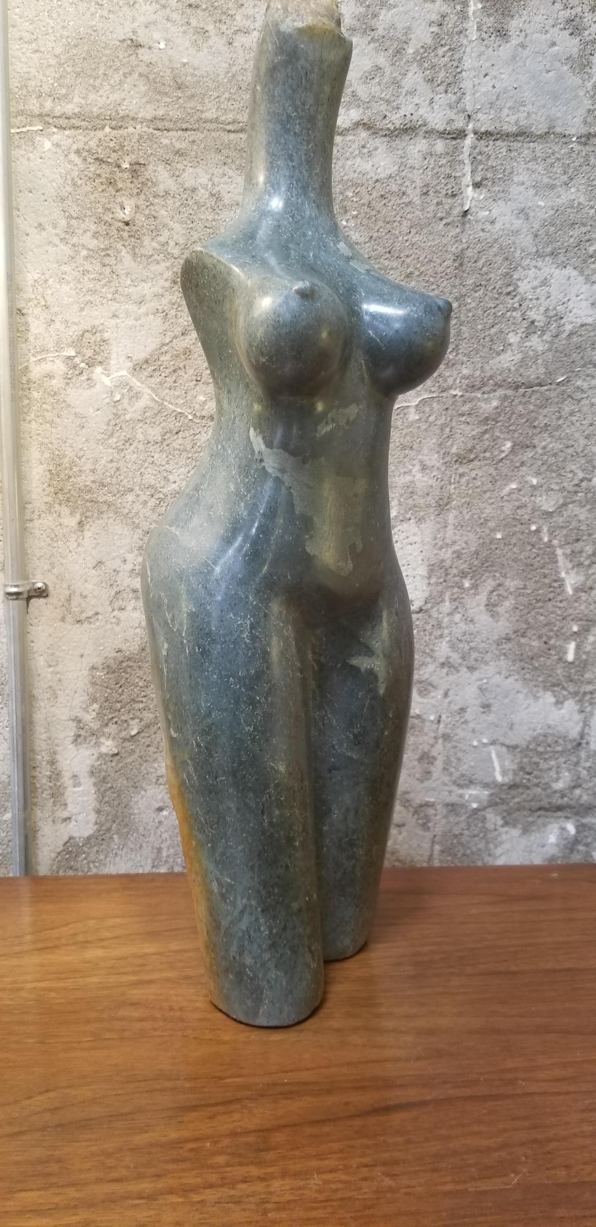 A hand-sculpted and polished stone sculpture of a woman's torso by South African artist Robert Chimika. Artist signed at base.