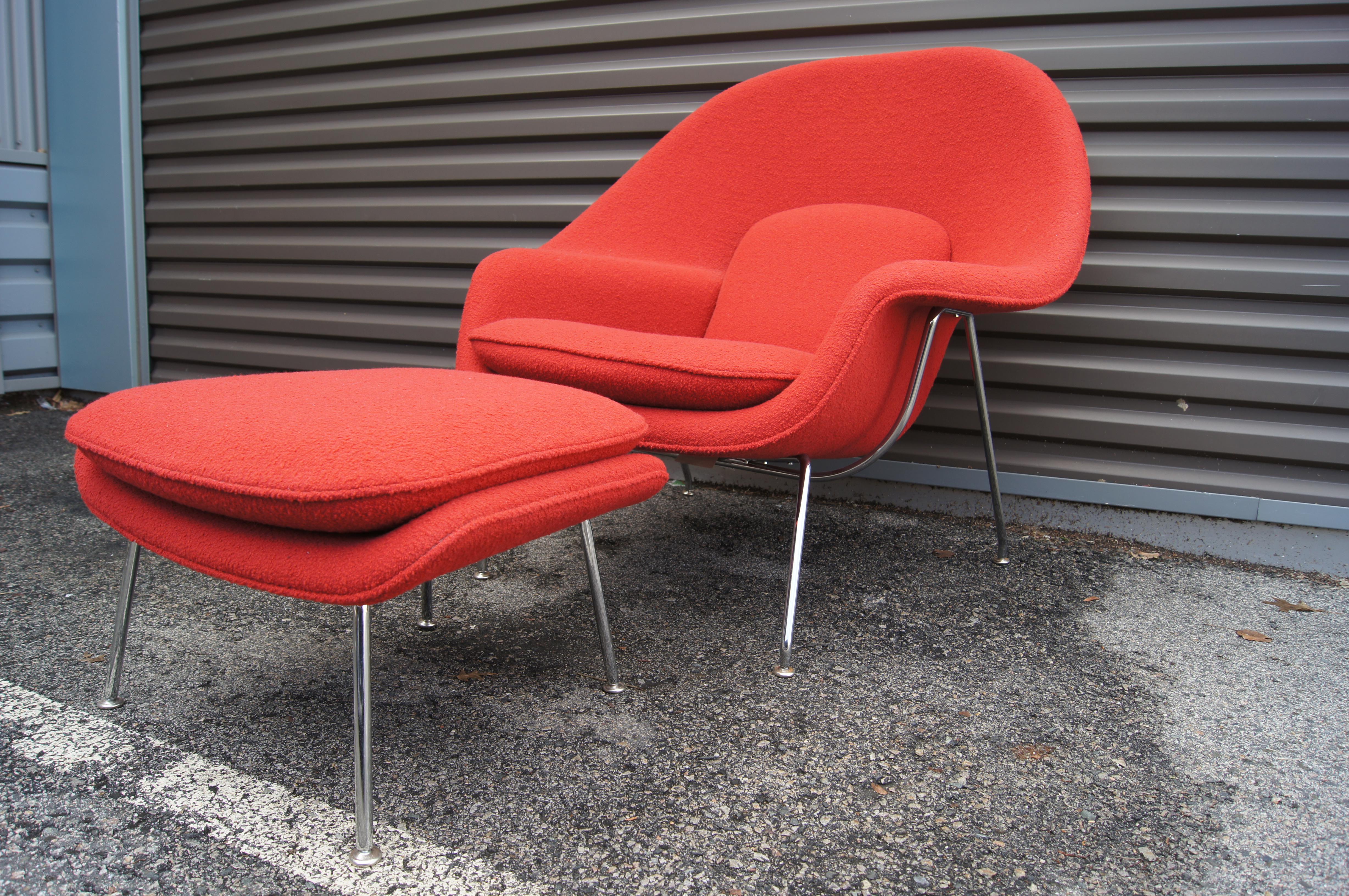 Designed for Knoll by Eero Saarinen in 1948, the Womb chair with ottoman has become a modernist classic. The contoured frame of fiberglass and polished chrome supports a deeply comfortable foam seat. This later production, never used, is upholstered