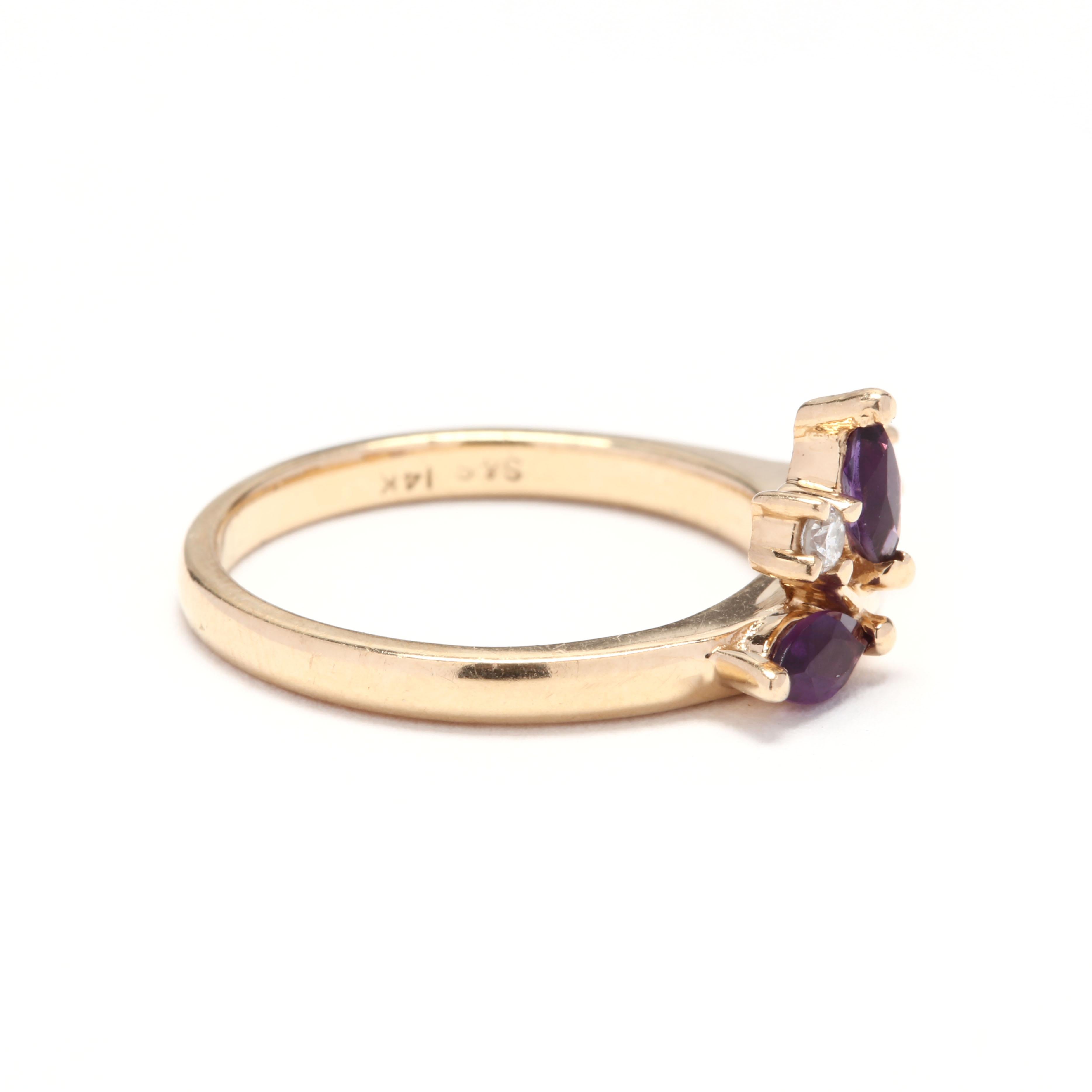 A vintage 14 karat yellow gold, amethyst and diamond vine ring. In a vine bypass design set with two marquise cut amethysts and two full cut round diamonds. The perfect complement to a solitaire ring.  February birthstone band with a unique look