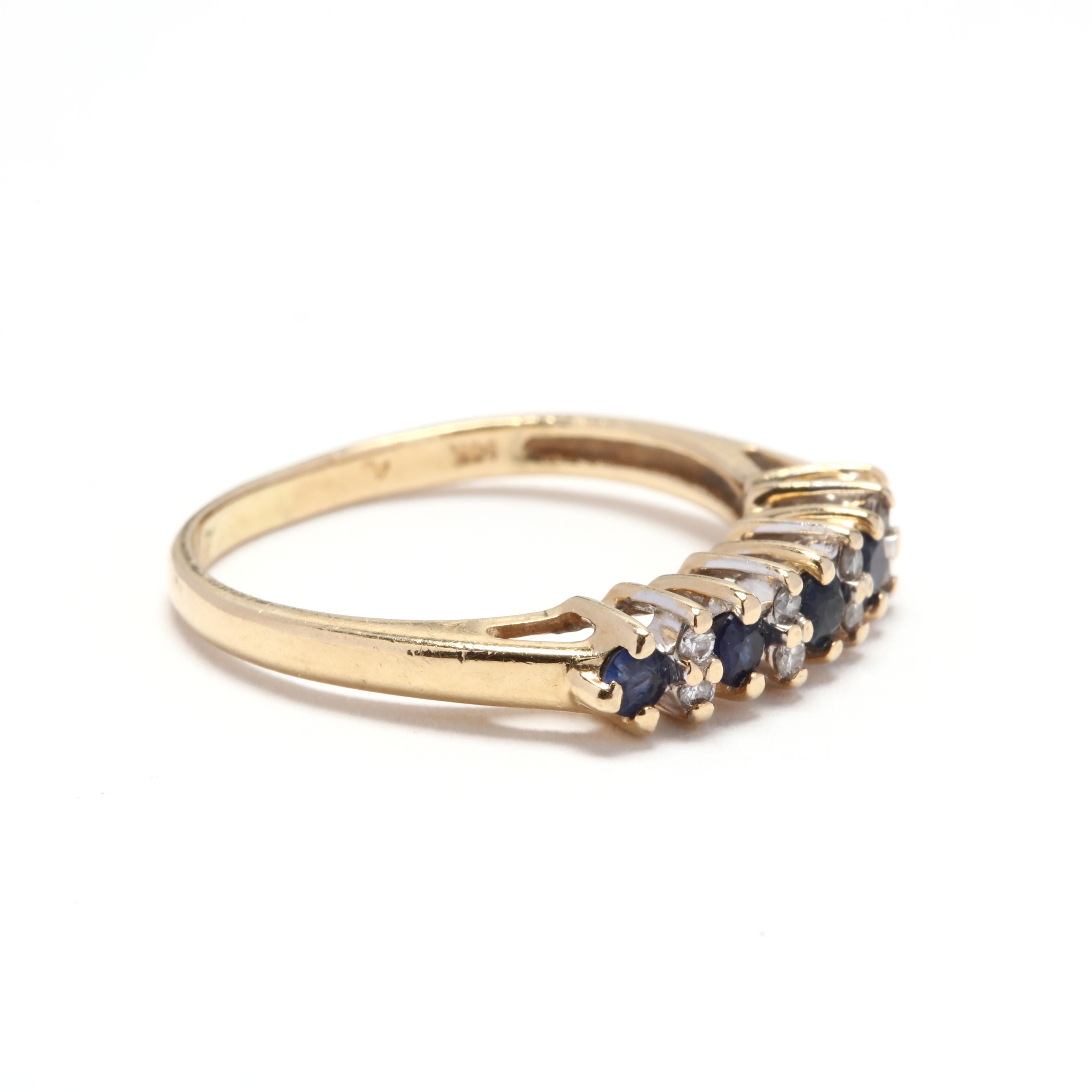 A 14 karat yellow gold, sapphire and diamond band ring. A prong set gemstone band with alternating round cut sapphires and diamonds. Special anniversary ring or special occasion ring.

Stones:
- sapphires, 5 stones
- round
- 2 - 2.25 mm
-