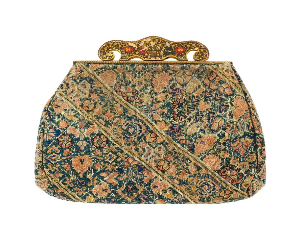 A vintage French womens bag, beautifully covered with 18th century Persian style tapestry featuring an elaborate floral and geometric tapestry design, predominantly in shades of blue, green, and earthy tones. The pattern is enriched with ornamental