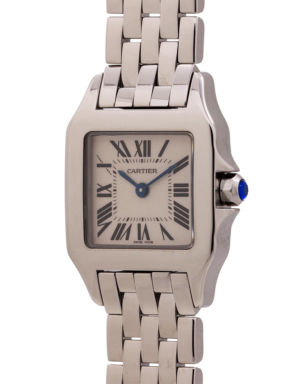 
Cartier stainless steel Demoiselle, circa 2000’s. 20mm case with sapphire crystal and blue sapphire cabochon crown. Classic antique white dial with Roman numerals and blue steel hands. Powered by battery quartz movement. Cartier flat link bracelet