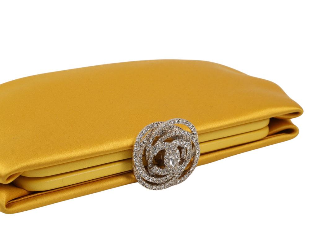 Just breathtaking.! This beautiful Satin clutch bag by Chanel is just exquisite especially the diamond-studded clasp which is made in the shape of a camellia as well as the signature CC emblem. An elegant and chic piece to add to any collection,
