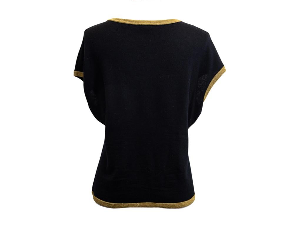 A wonderful Chanel Pre fall 2019 Jumper for sale. Made from black cashmere and wool and edged with gold detail. This jumper was from the 2019 Pre Fall Egyptian collection. Do look at photos as there is some bobbling under the arms but the price has