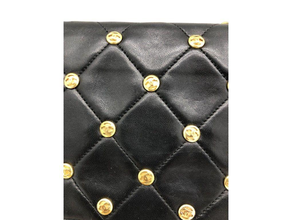 What an exquisite, Vintage piece of craftmanship from Chanel. This bag is made from black calfskin leather and the CC studded charms on the bag are just stunning. Finished off with a gold chain strap that allows the bag to be worn handheld, shoulder