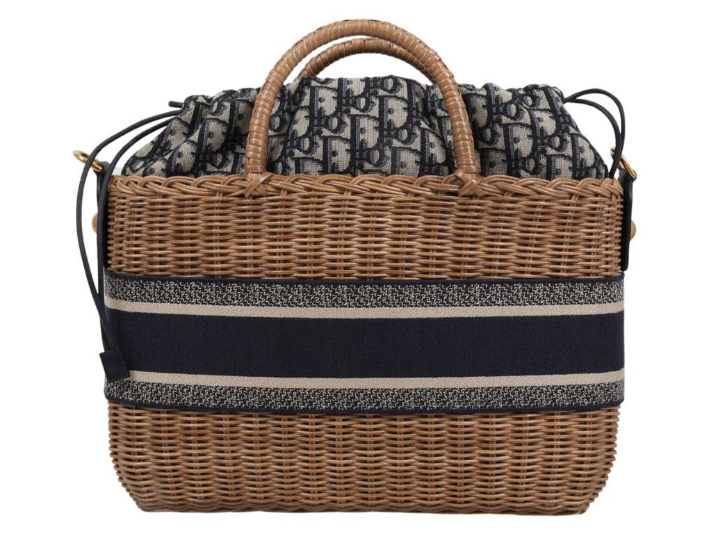 Gorgeous Dior Wicker basket which is timeless for sale.  Crafted in natural hand-woven wicker and features a blue Dior Oblique jacquard interior pouch with zipped pocket and a drawstring closure.  'CHRISTIAN DIOR' signature on the front while the