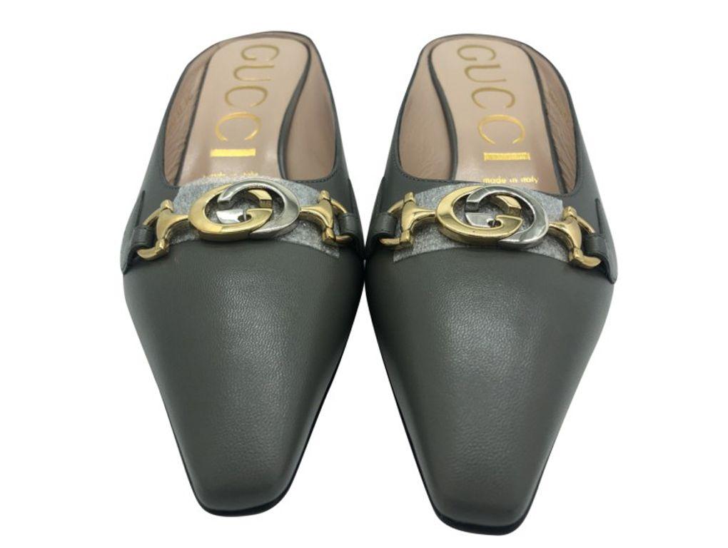 Stunning pair of Gucci pointed Grey Leather Mules which feature a pointed toe, branded leather insole, 50 mm heel and gold tone buckle detailing to the front. An unworn new pair which have been stored since purchase. Save on these as the Retail