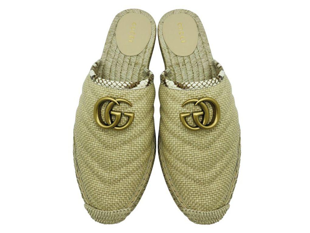 Excellent Gucci Espadrille Mules for sale in a size 38 (UK5). A new pair - purchased and stored.
BRAND	
Gucci

FEATURES	
GG Logo detail, raffia, trimmed with elaphe, underpinned by rubber for grip, Sole