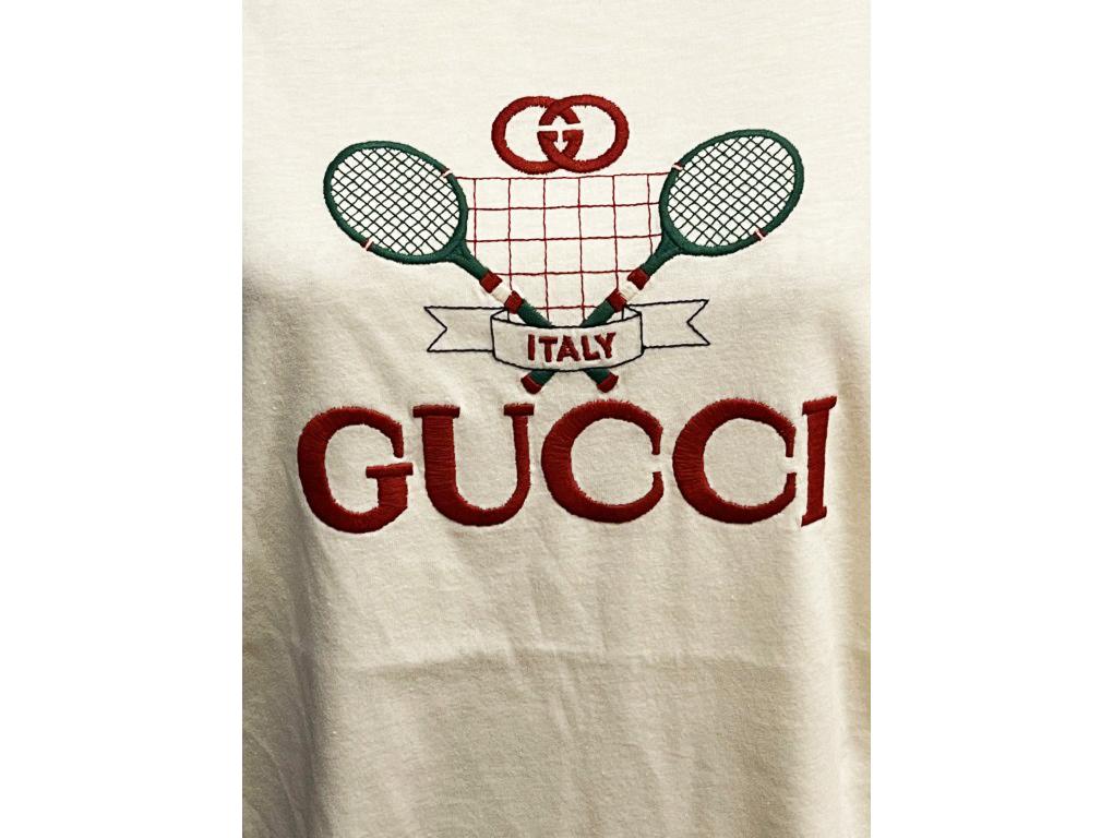 BRAND	
Gucci

FEATURES	
Gucci Tennis logo, round neck, Short Sleeve

MATERIAL	
Cotton

COLOUR	
Cream

ACCESSORIES	
Tag

CONDITION	
New

MEASUREMENTS	
medium

PRODUCT TYPE	
Clothing, T-Shirt, Top