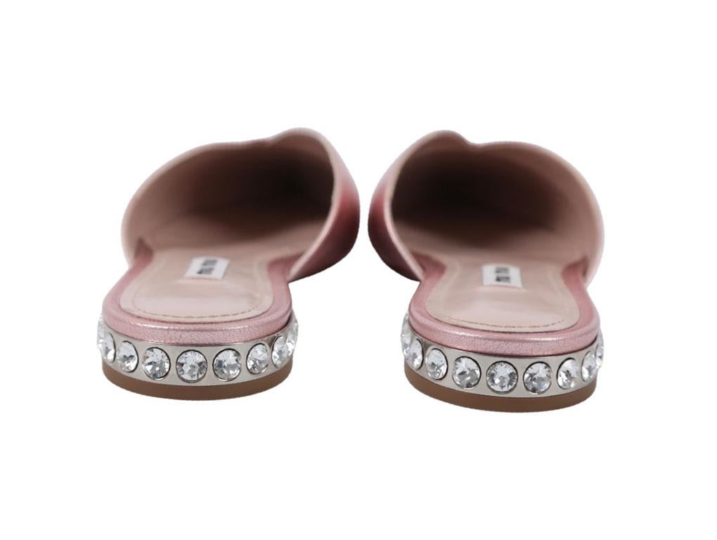 Stunning pair of Miu Miu pointed flat mules with crystal embellised heel in a size 36 (UK 3). An unused pair – purchased, stored and never used.



BRAND	

Miu Miu



FEATURES	

Heel Embellished Crystals, Metallic Leather, Pointed