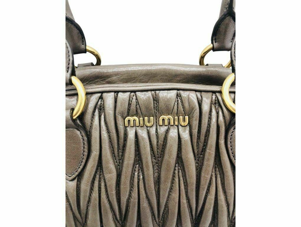 A beautiful Matelasse leather Miu Miu bag in grey calf leather. There is a lovely sheen on the leather which really makes the bag stand out. Wear handheld or on the crook of your arm or attach the strap and wear on the shoulder. Gorgeous piece and