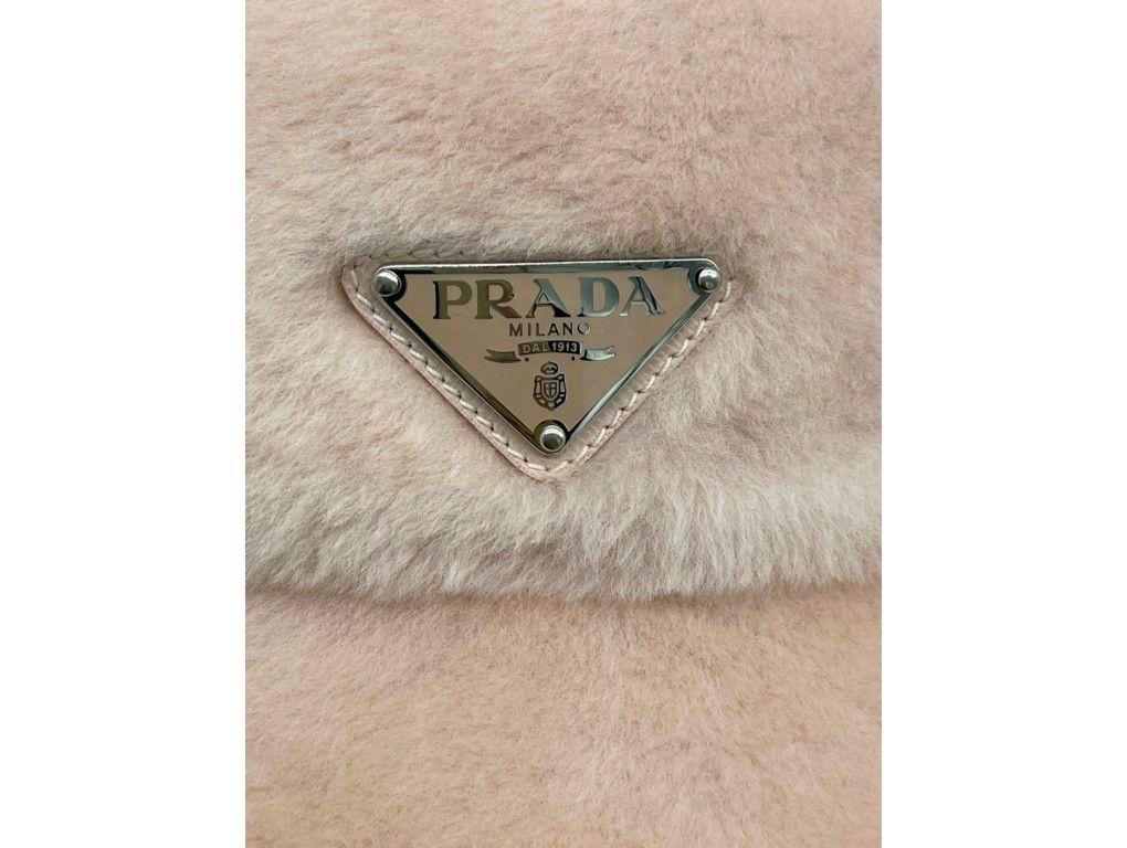 This fluffy Shearling Prada hat is divine. Finished off with the logo plaque on the front definitely is a statement piece. A new item for sale.


BRAND	
Prada

FEATURES	
Enameled metal triangle logo, logo plaque, silk lining