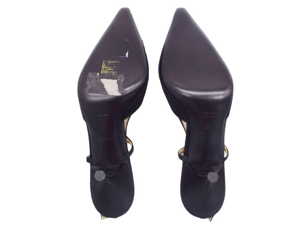 Exquisite pair of pointed, kitten heel shoes by Prada in black satin with wooden detail on the front.  Made in a size 37 (UK 4) and includes a Prada Box and dustbags. A preloved pair in Excellent condition.
BRAND	
Prada

FEATURES	
Kitten Heels,