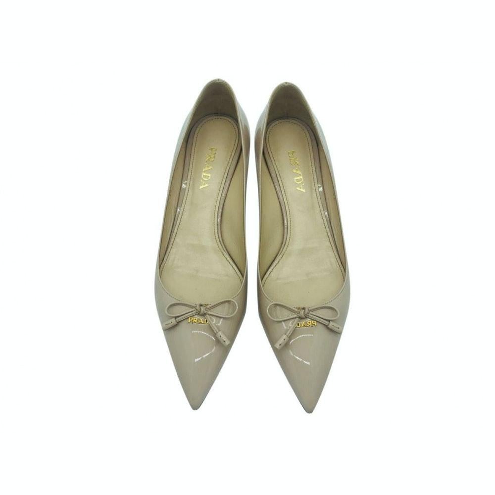 Exquisite pair of pointed, small heel shoes by Prada in beige patent leather.  Made in a size 39 (UK 6) and includes a Prada Box but not the original one. A preloved pair in Excellent condition with a few marks on the back of the heel so do look at