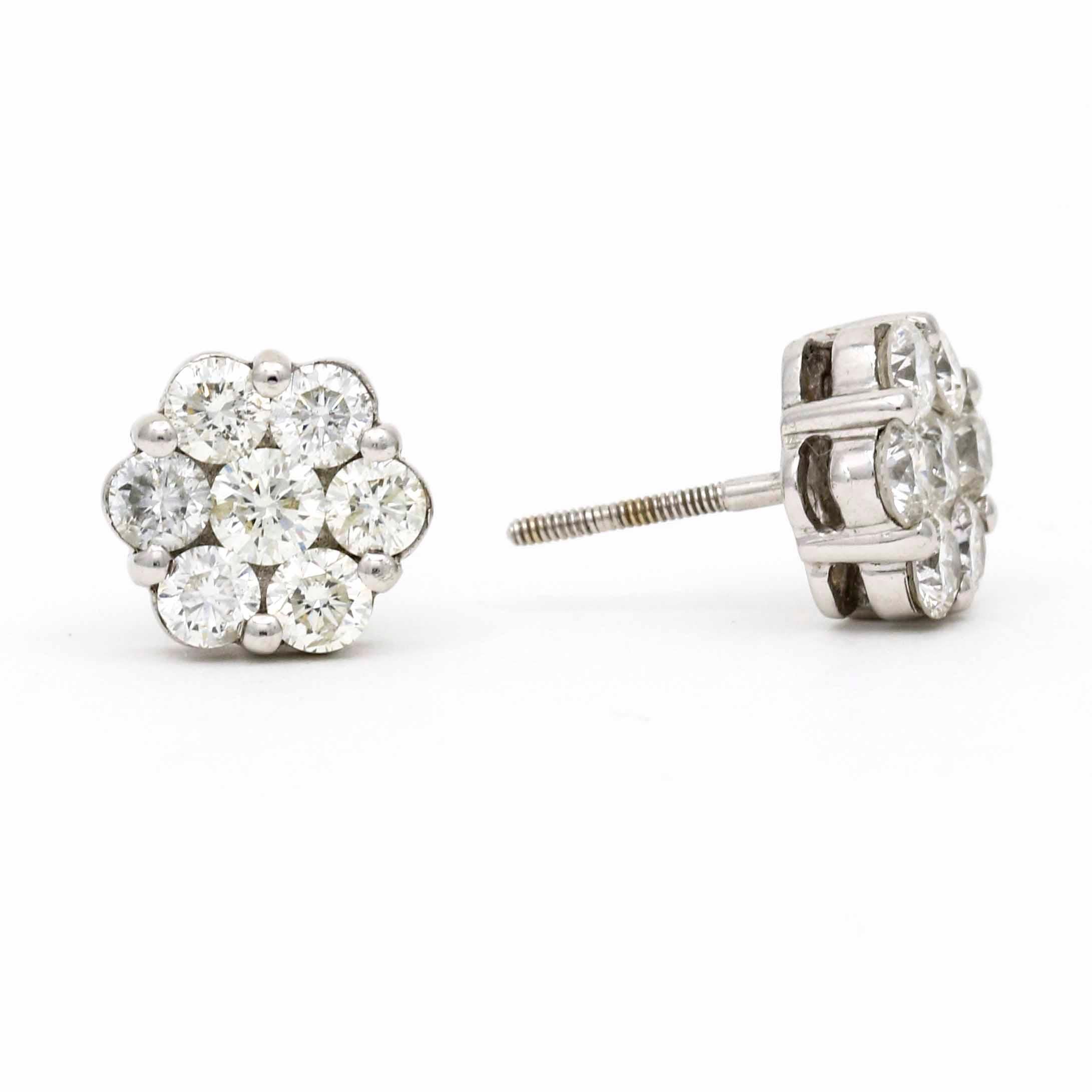 Highlight your elegance with these sparkling diamond earrings crafted in 18k white gold. The cluster of diamonds looks like a bigger diamond, with seven brilliant round-cut diamonds that add sparkle to any occasion. They're in excellent condition
