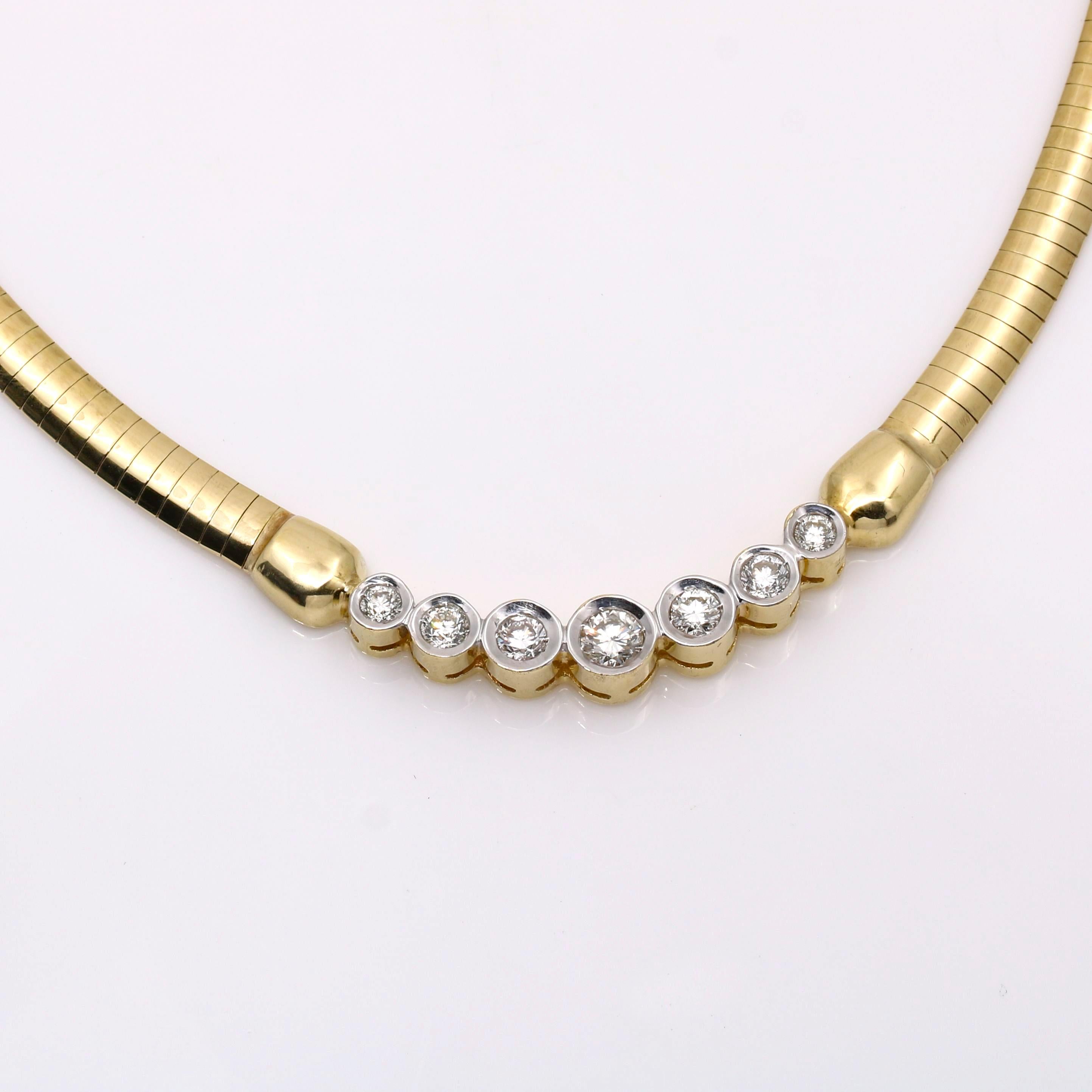 This diamond necklace is a combination of elegance and beauty. The yellow gold omega chain and the beautiful 7 graduated high-quality diamonds are perfectly combined to make a stunning piece that will make you shine like a diamond. It is in
