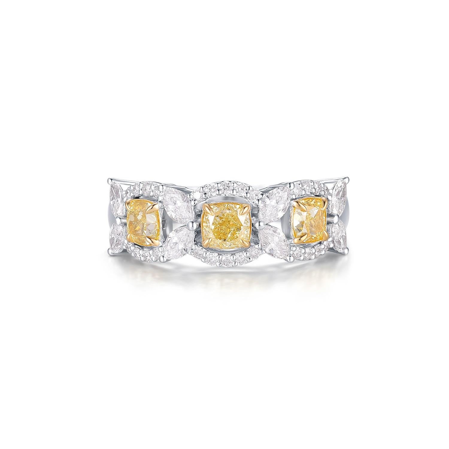 This exquisite ring is crafted from 18-karat white gold and features a stunning array of diamonds. At the center, three fancy yellow diamonds, totaling 1.03 carats, are beautifully set to enhance their vibrant color. These yellow diamonds are