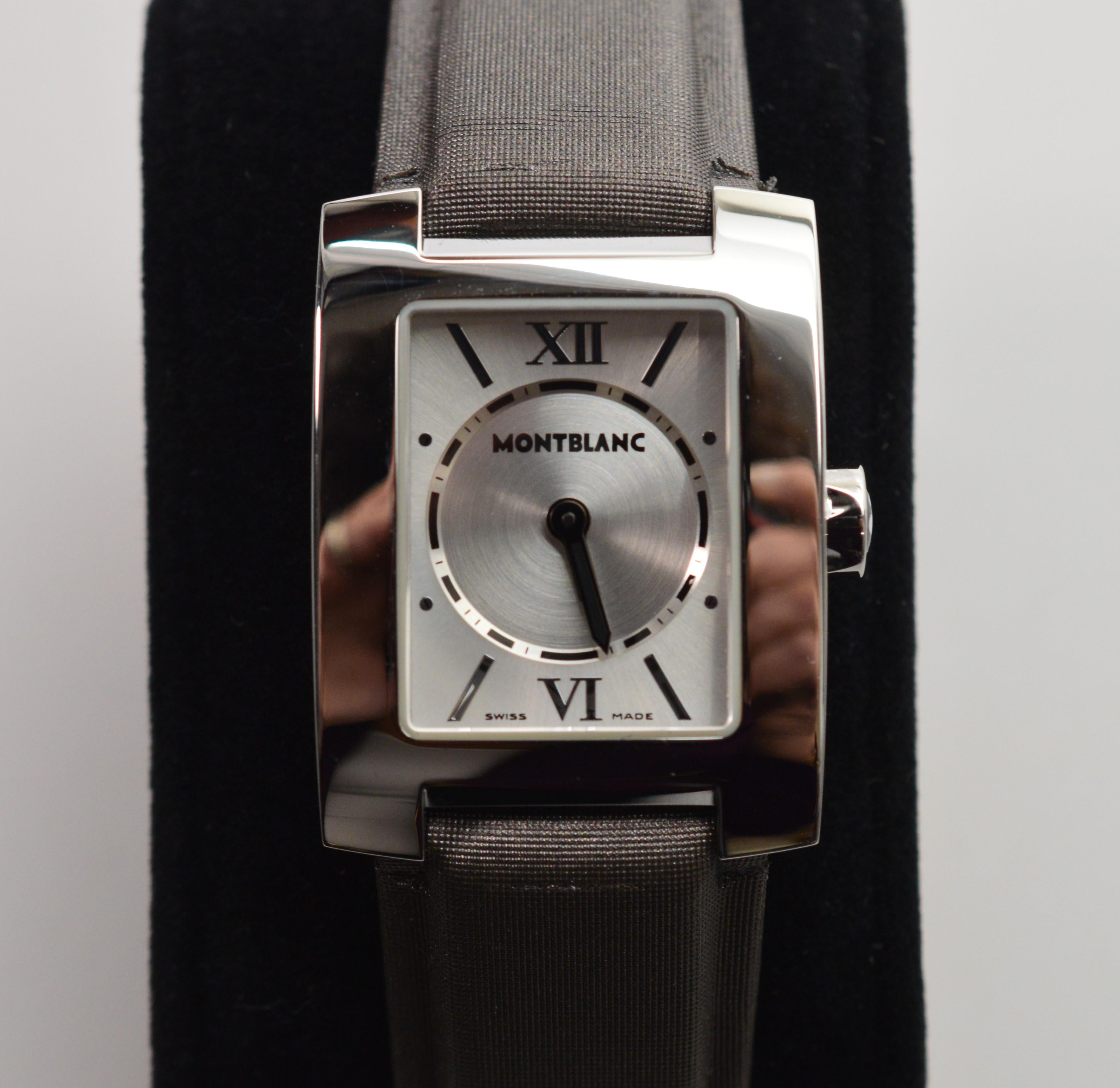 Contemporary Women's Montblanc Stainless Steel # 7047 Quartz  Profile Wrist Watch, in mint condition and in it's original box. The leather wristband is covered in an elegant slate fabric and measures eight inches including the head and is